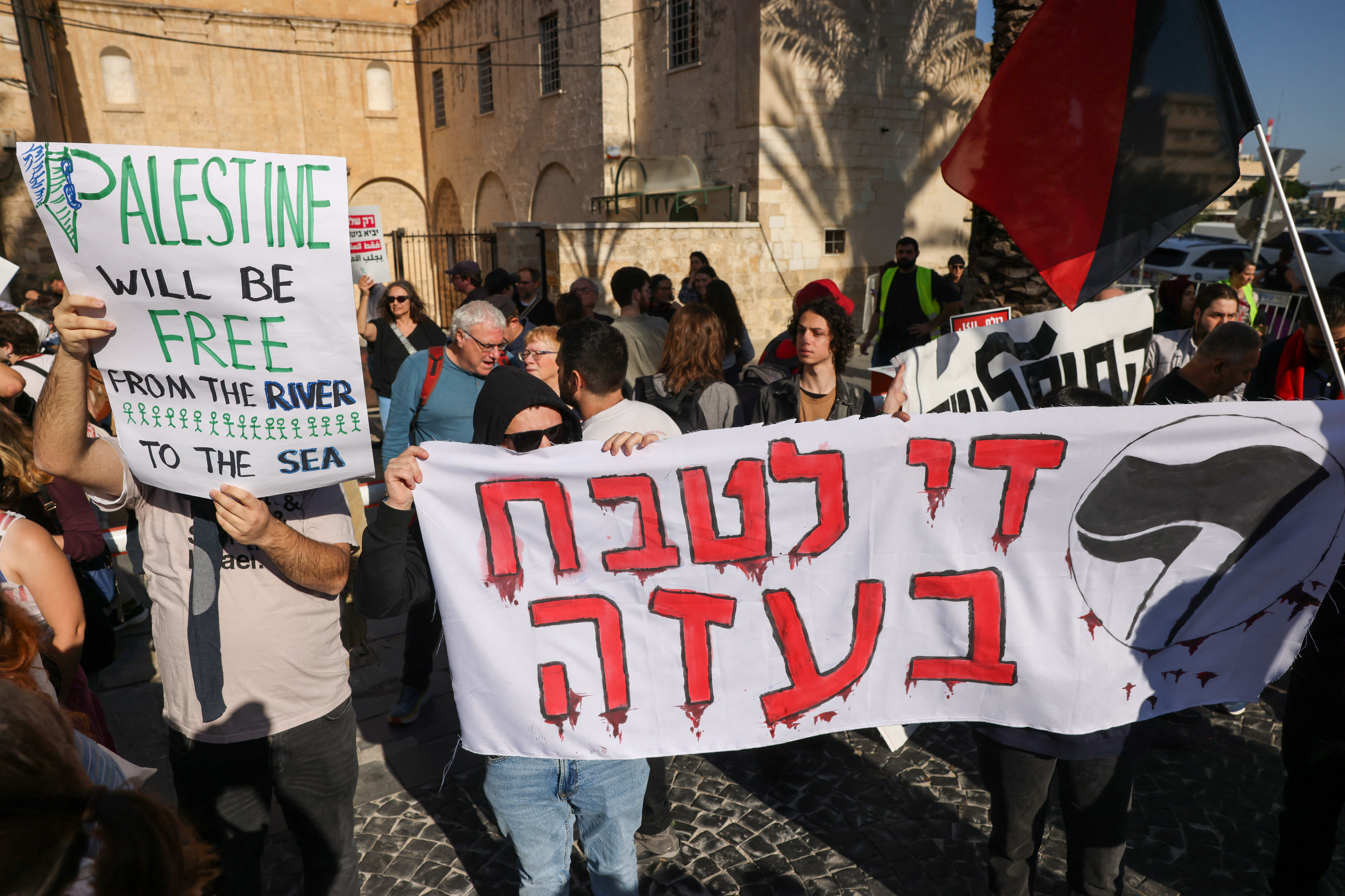People hold placards as they take part in a protest calling for a ceasefire and for the release of Israeli hostages held in Gaza