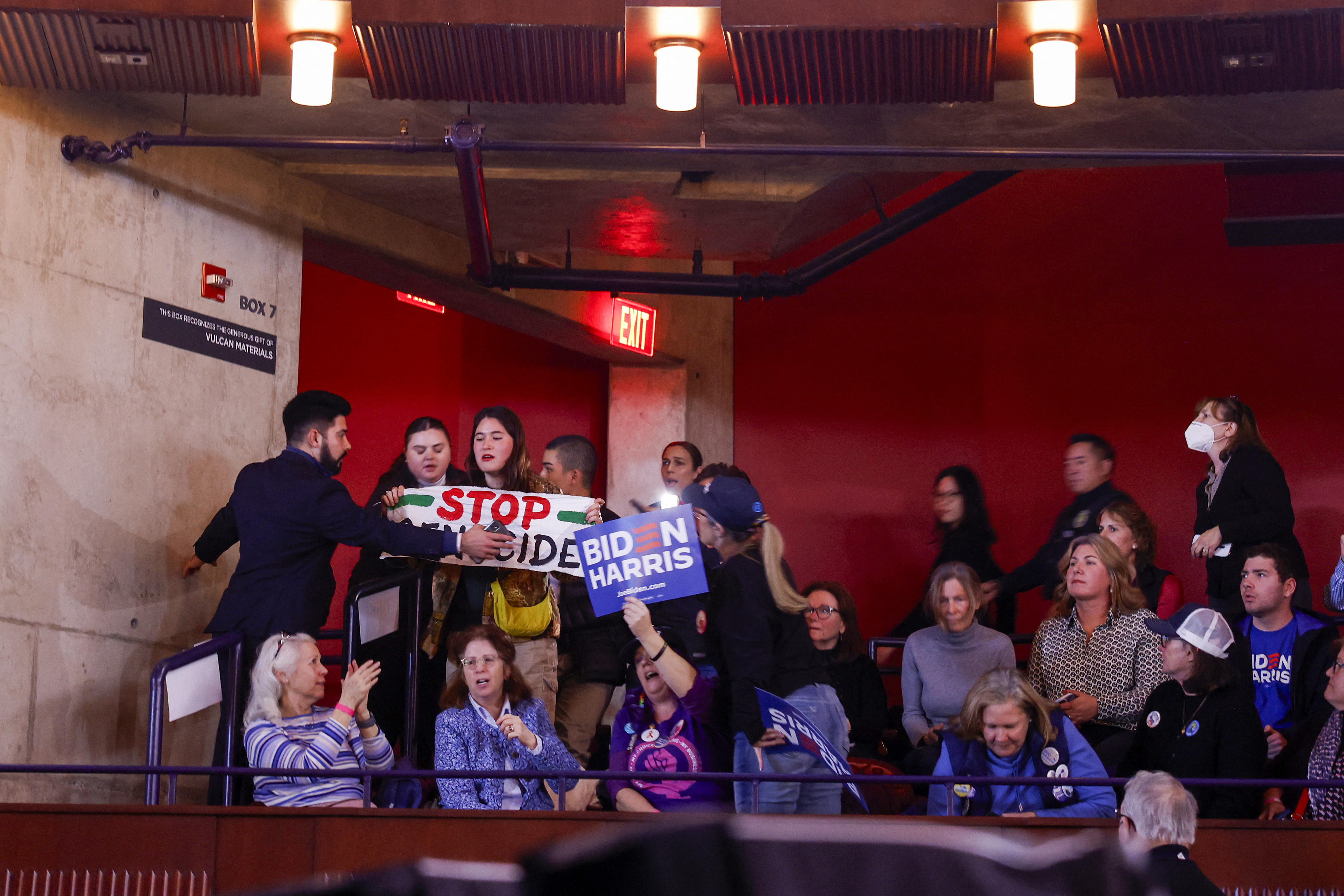 MANASSAS, VIRGINIA - JANUARY 23: A protester holds a sign reading "Stop Genocide" as they are removed from the crowd while U.S. President Joe Biden speaks at a Reproductive Freedom Campaign Rally" at George Mason University on January 23, 2024 in Manassas, Virginia. During the first joint rally held by the President and Vice President, Biden and Kamala Harris spoke on what they perceive as a threat to reproductive rights. Anna Moneymaker/Getty Images/AFP (Photo by Anna Moneymaker / GETTY IMAGES NORTH AMERICA / Getty Images via AFP)