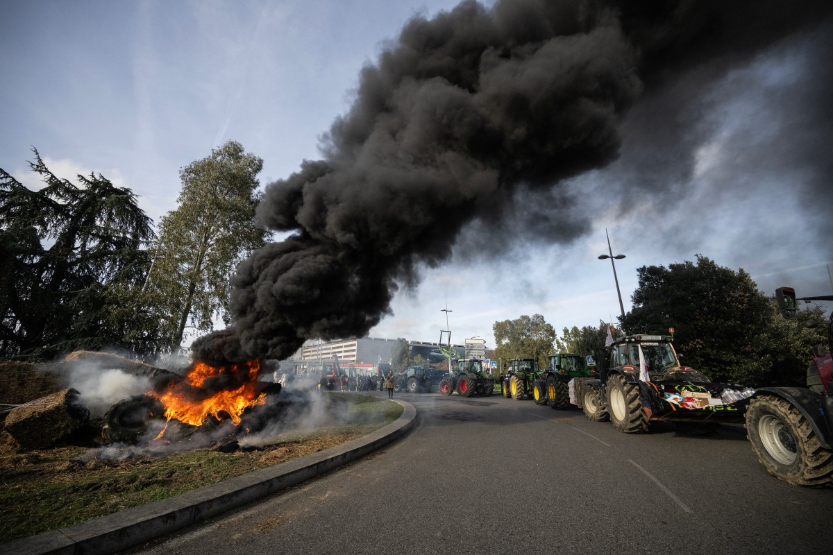 Farmers drive their tractors during a protest