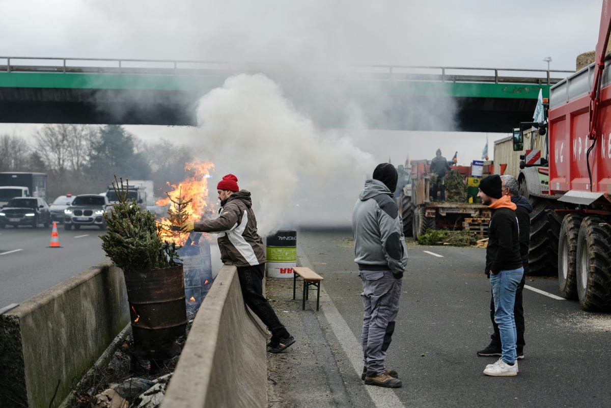 Farmers drive their tractors during a protest