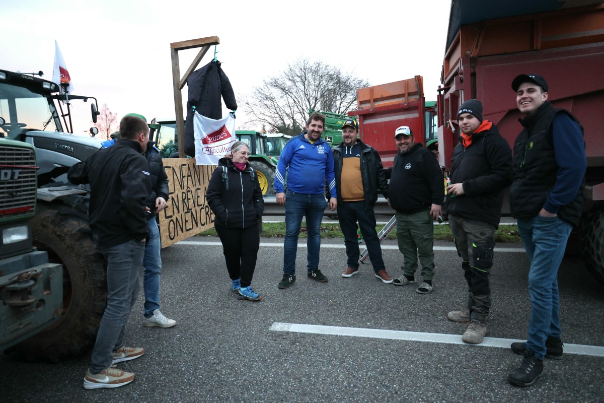 Farmers drive their tractors during a protest