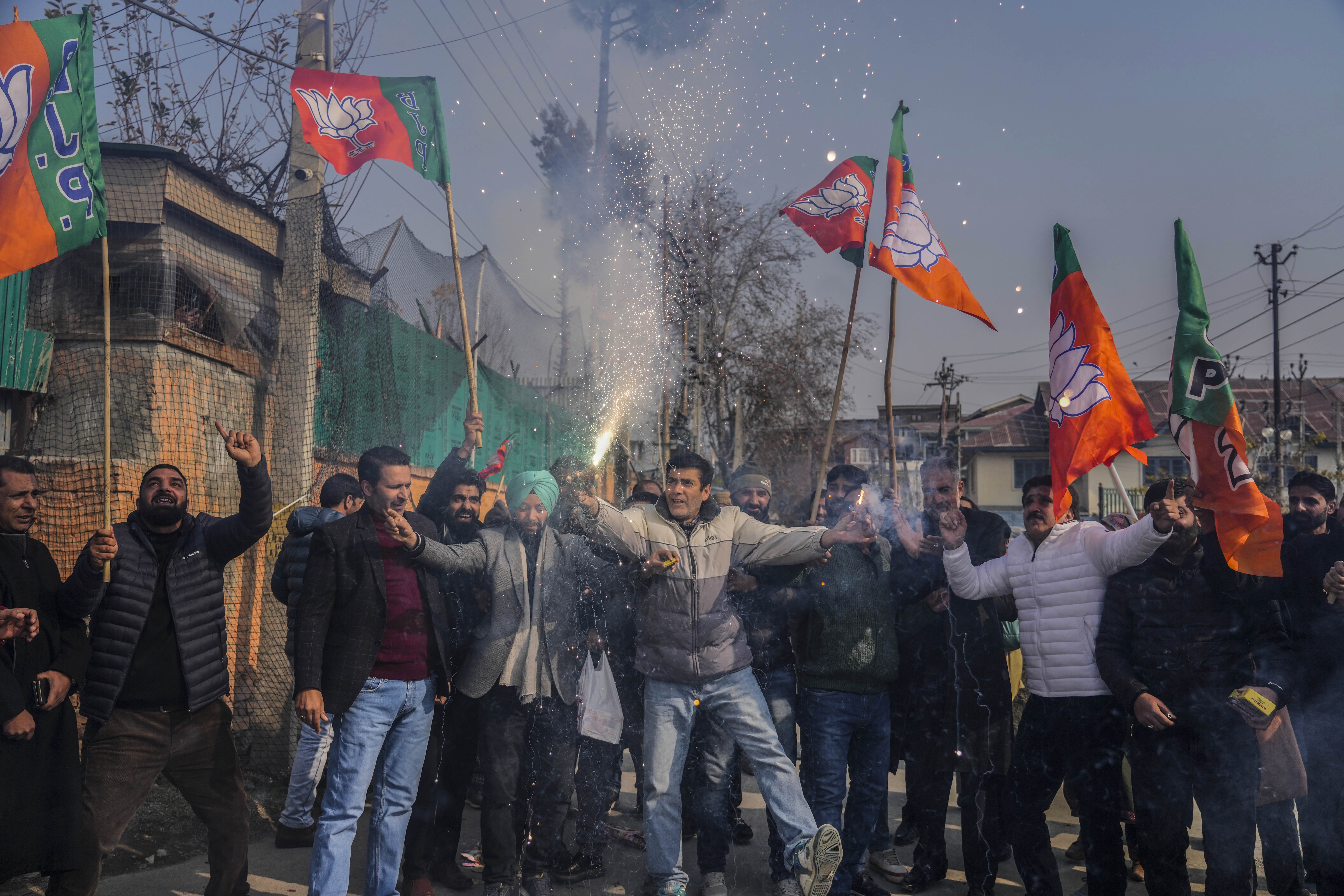 Supporters of India's ruling Bharatiya Janata Party, or BJP, light firecrackers as they celebrate winning elections in three states in Srinagar, Indian controlled Kashmir, Monday, Dec. 4, 2023. (AP Photo/Mukhtar Khan)
