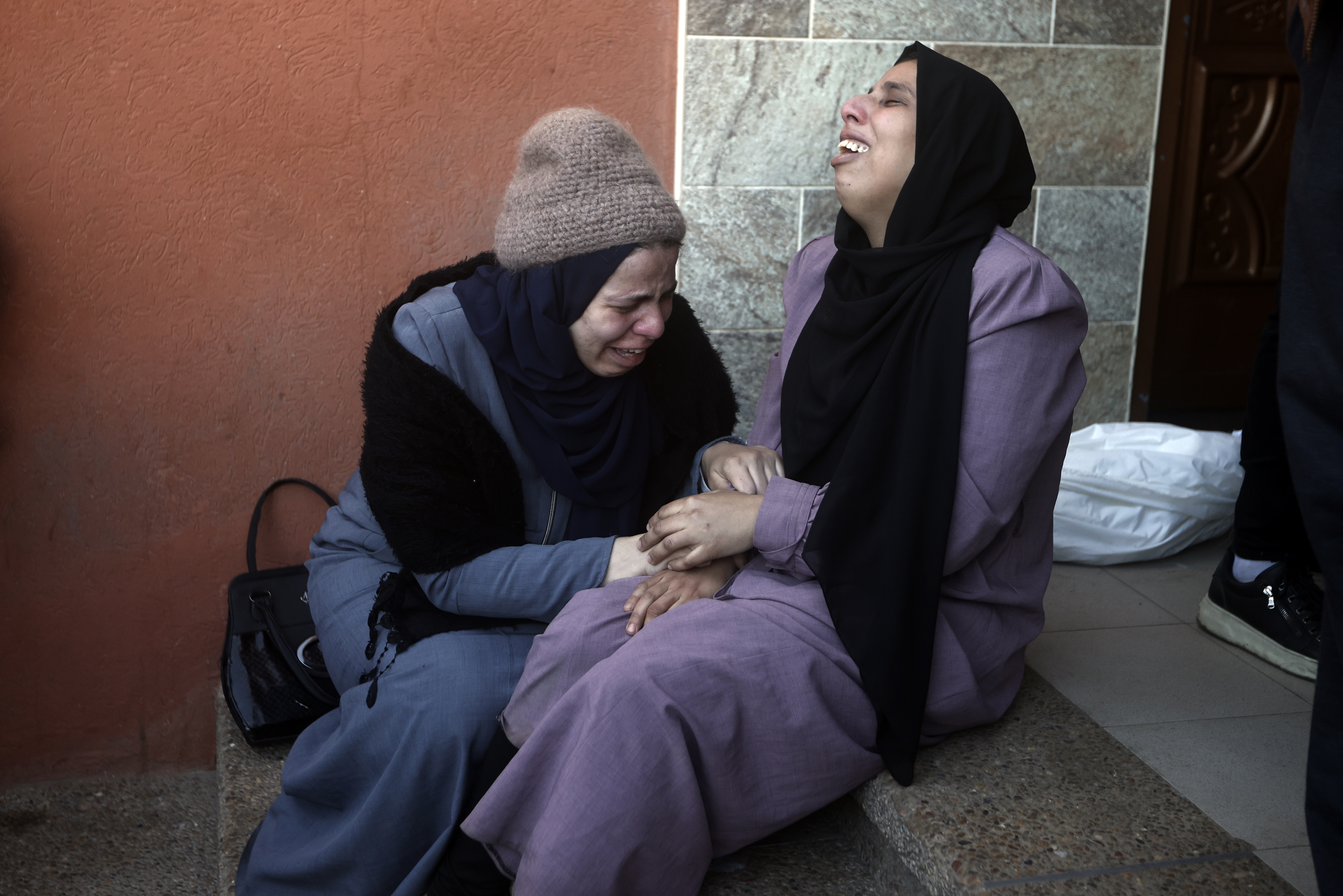 Palestinians mourn relatives killed in the Israeli bombardment of the Gaza Strip outside a morgue in Khan Younis on Thursday.