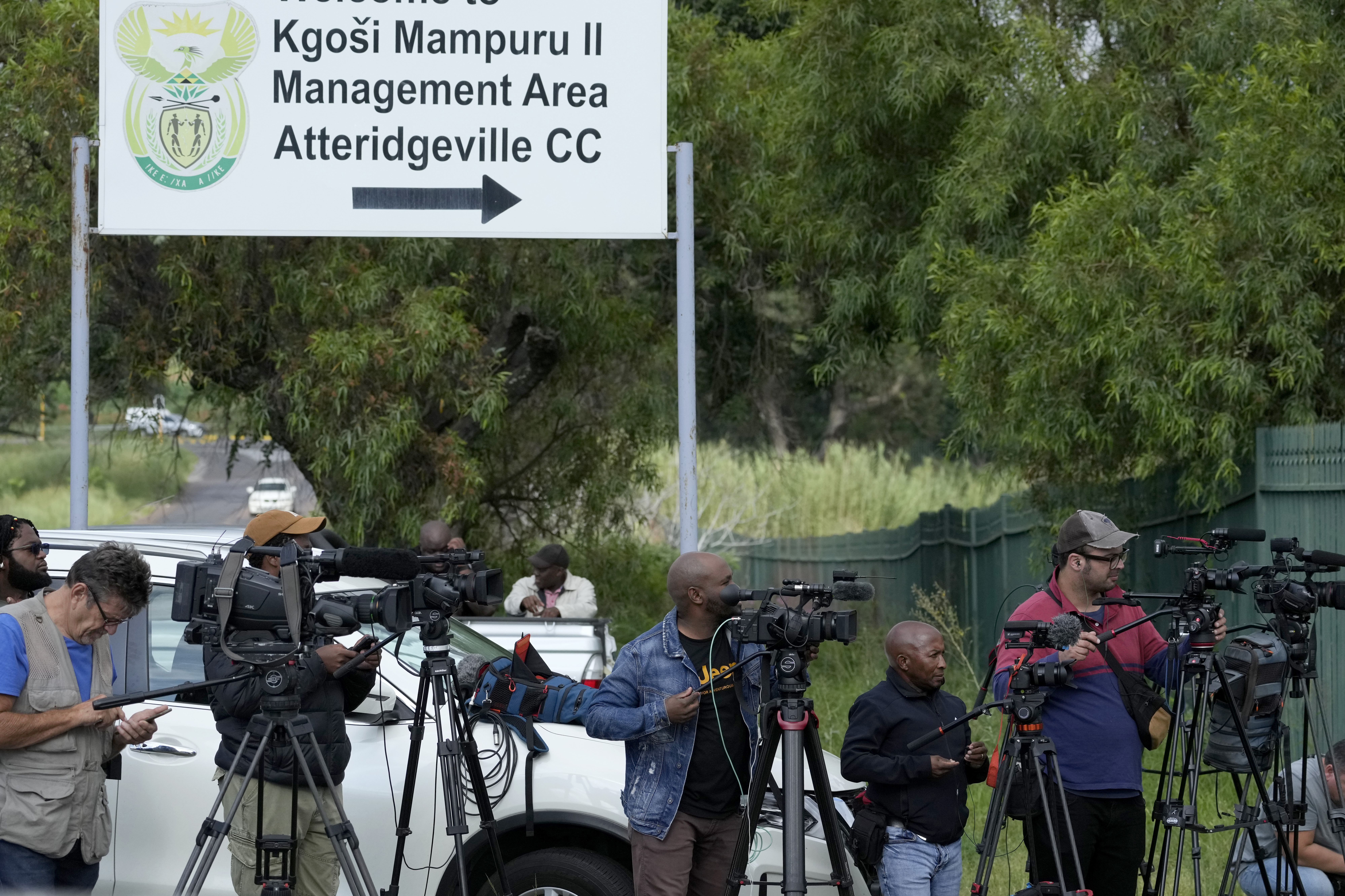 Members of the media stand outside the main gate of the Atteridgeville Prison in Pretoria, South Africa, Friday, Jan. 5, 2024. South African athlete Oscar Pistorius was due to be released from prison on parole Friday