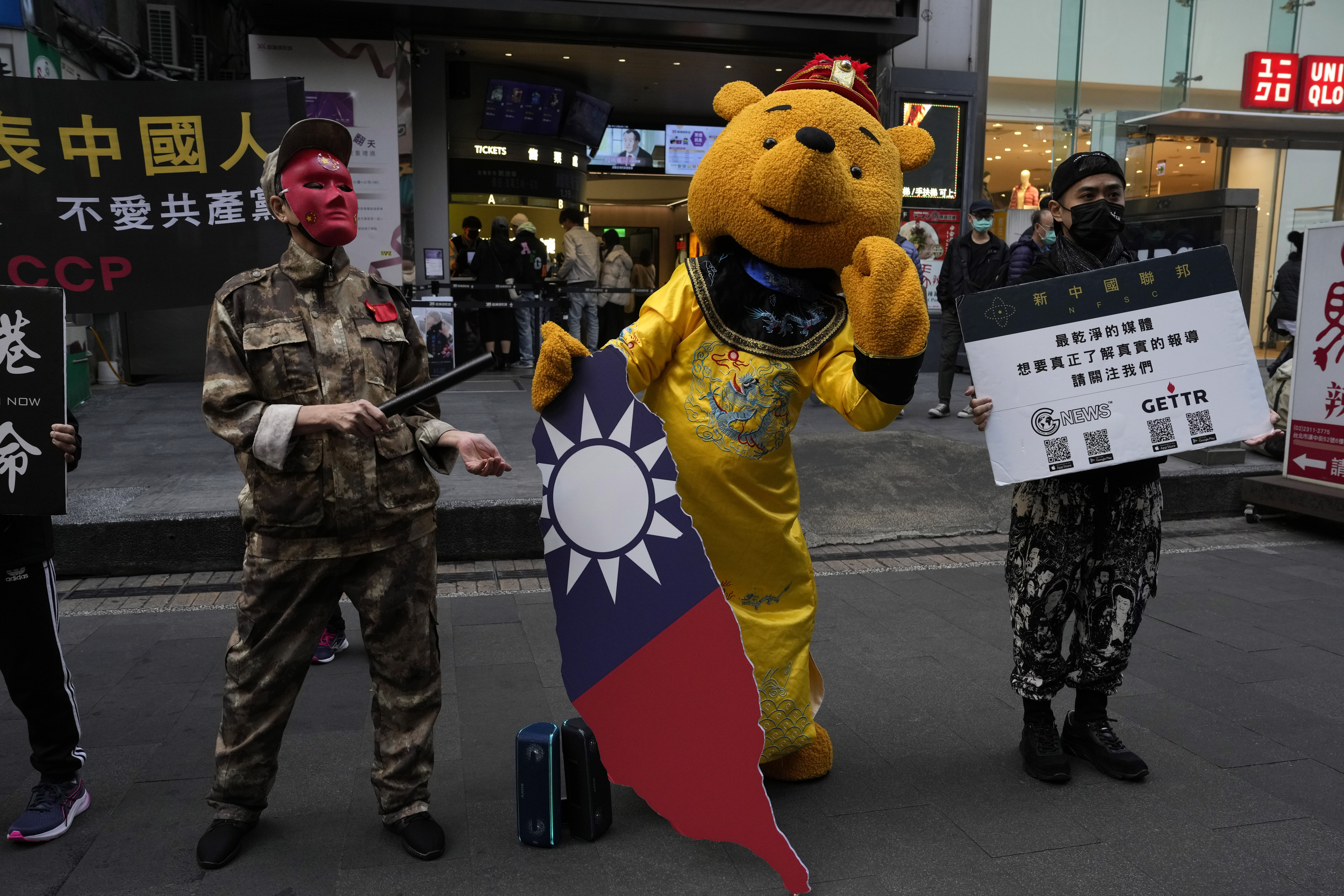 Taiwanese people protest against the communist party. One is dressed as Winnie the Pooh a representation of Chinese president Xi Jinping