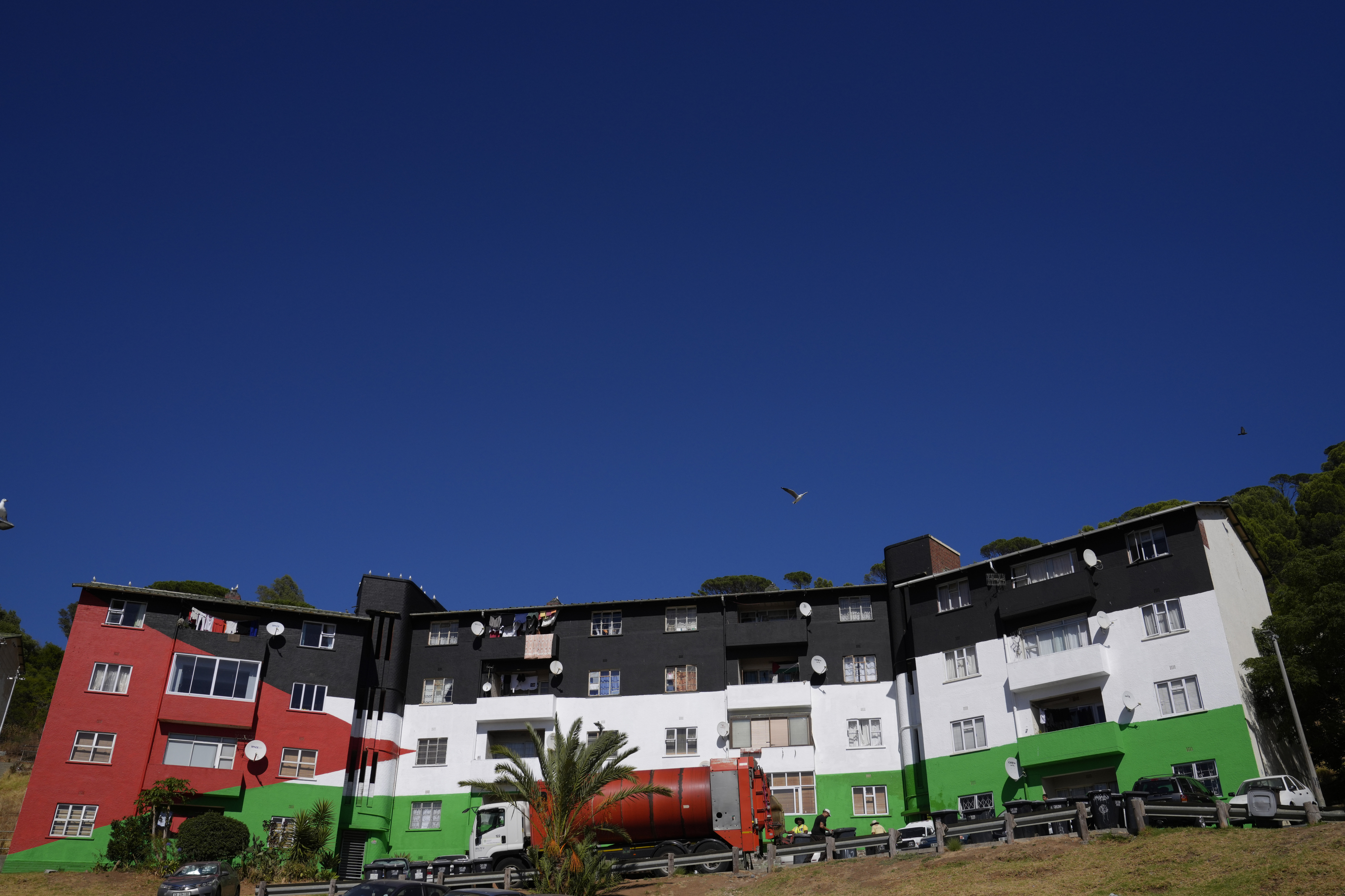 A view of an apartment building painted in the colours of the Palestinian flag, in the Bo-Kaap neighbourhood of Cape Town