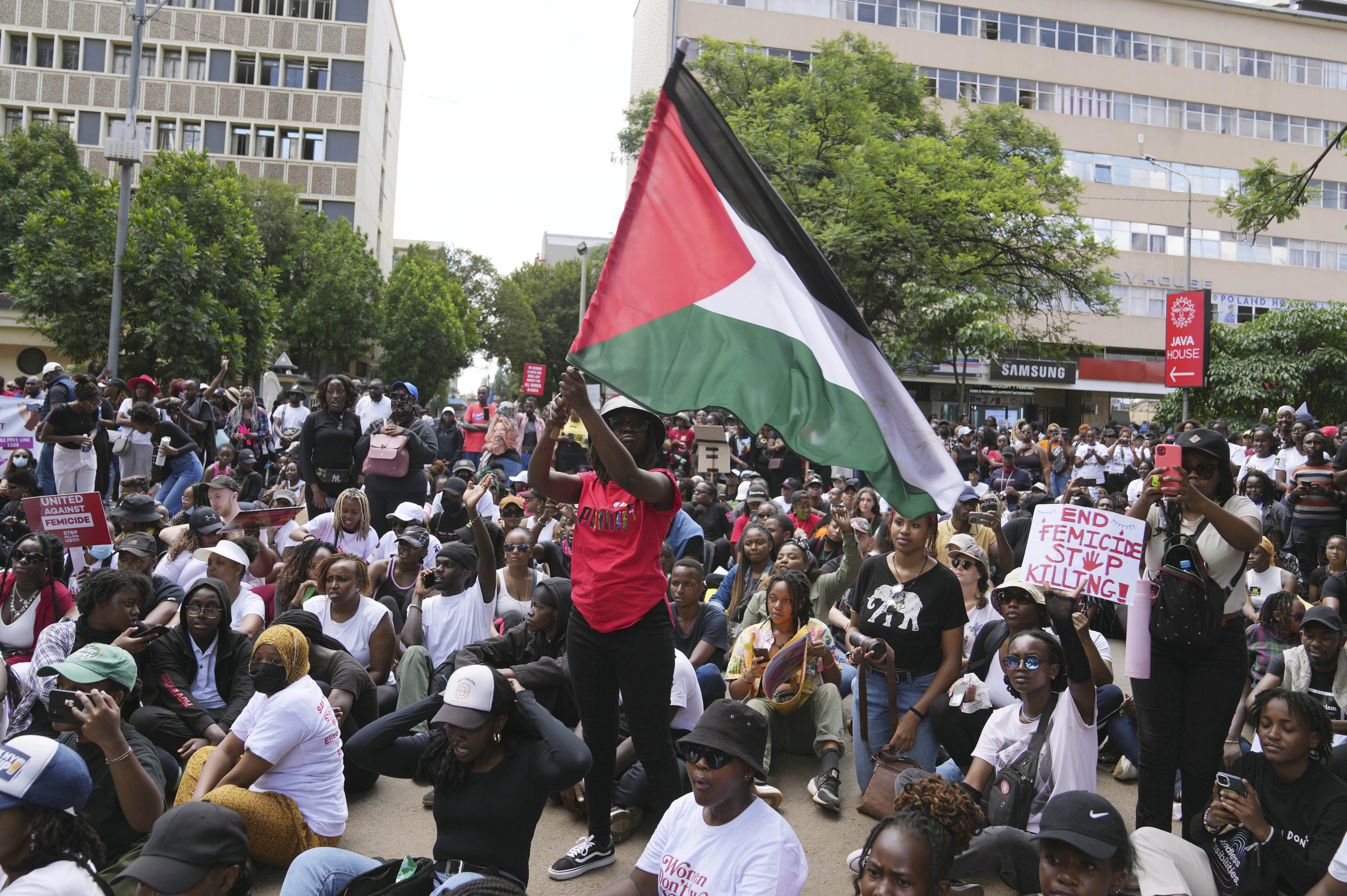 A protester holds a Palestinian flag during a procession to protest against the rising cases of femicide, in downtown Nairobi, Kenya Saturday