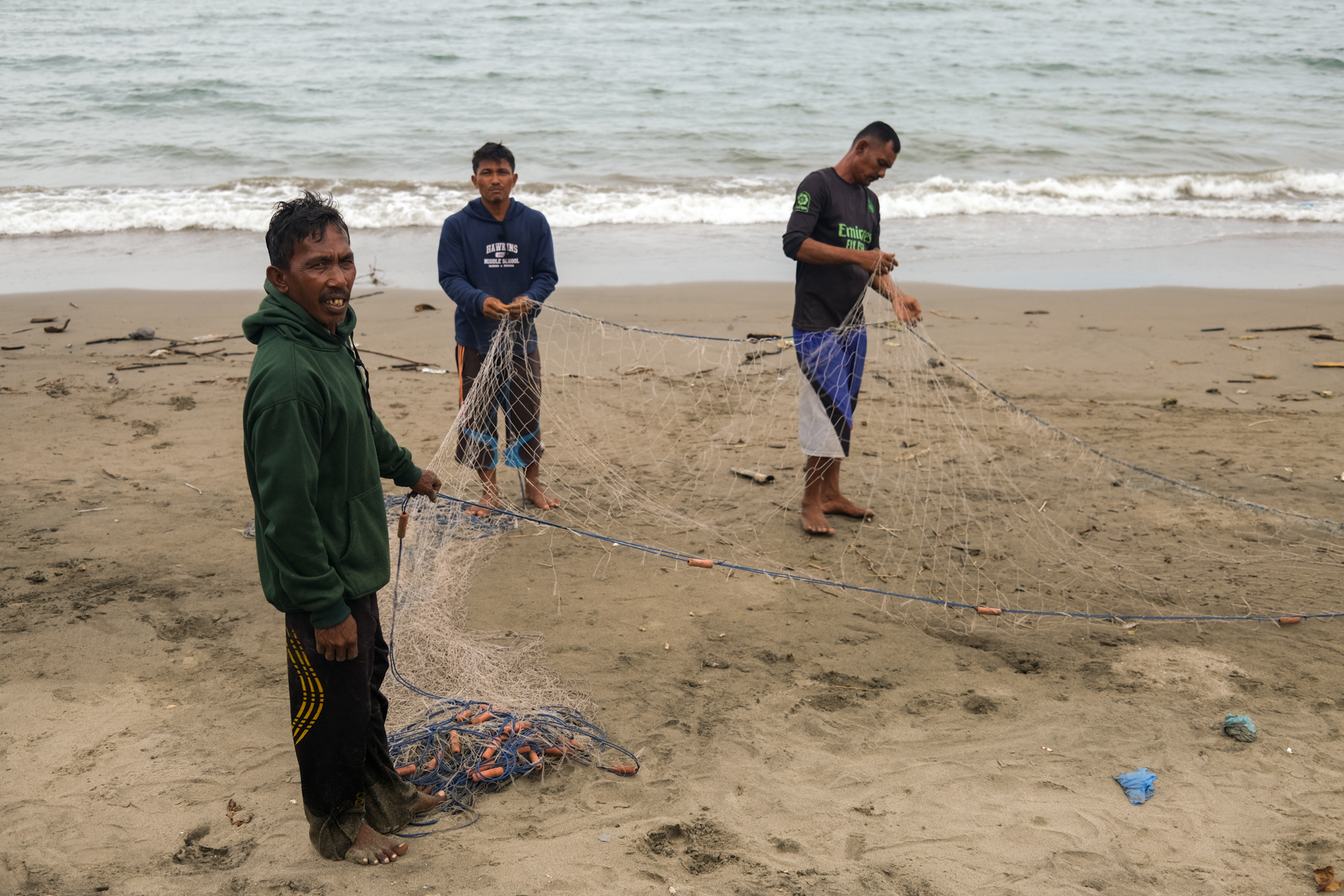 These fishermen live in a village, on the same beach as the temporary shelter for the refugees.
