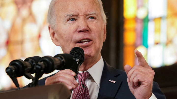 Image of President Joe Biden speaking into a microphone.