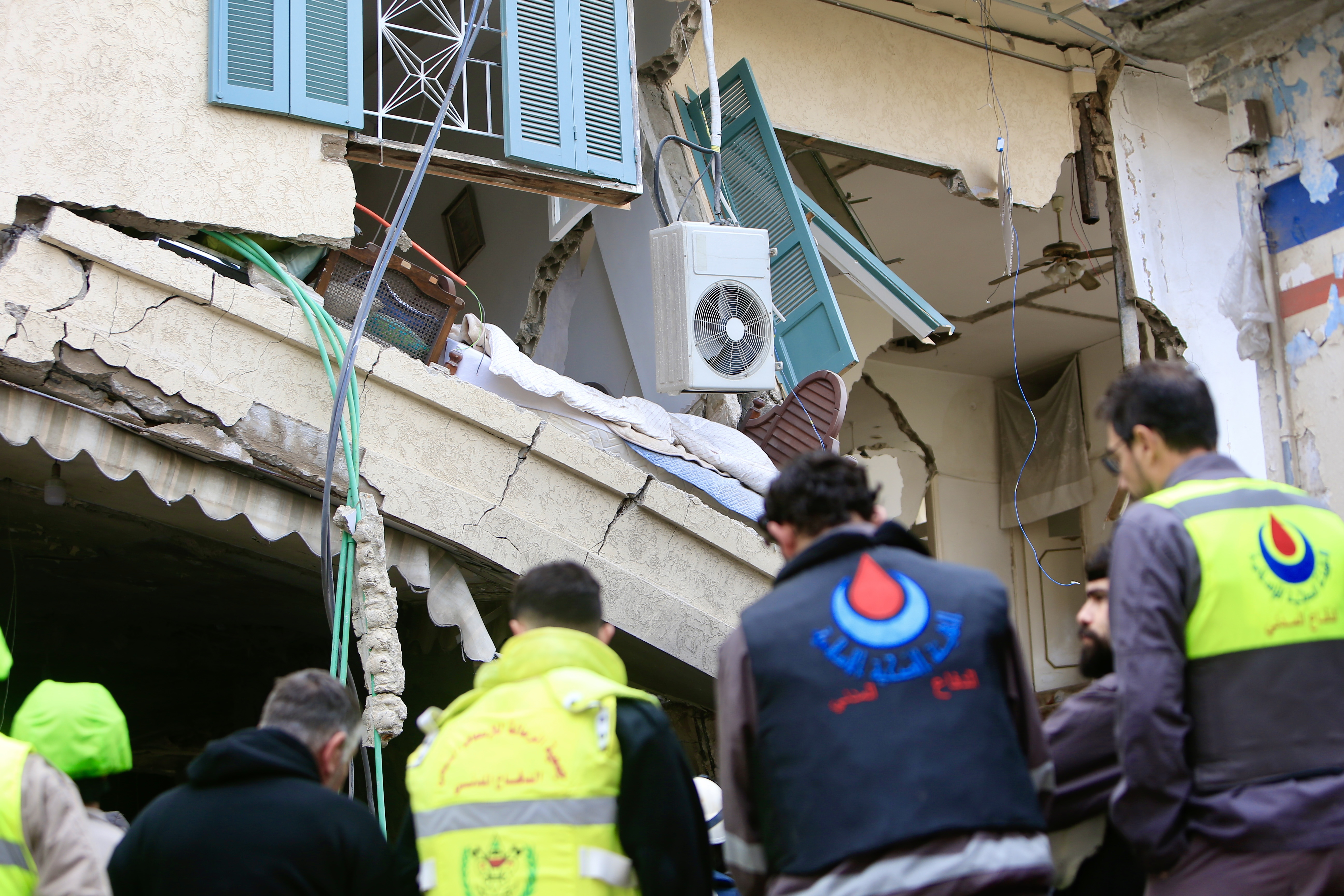 Rescuers work at a damaged buidling following an Israeli military strike in Nabatiyeh