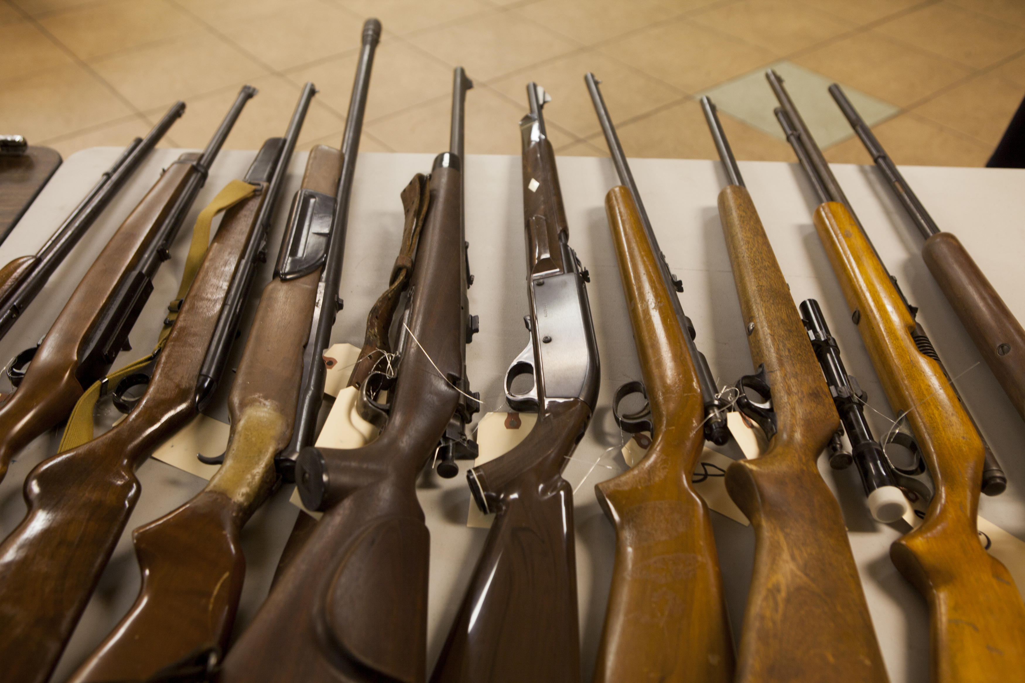 San Diego law enforcement officials show collected weapons during a gun buy-back December 21, 2012 in San Diego, California. Hundreds of San Diegans lined up to exchange their unwanted guns for gift cards