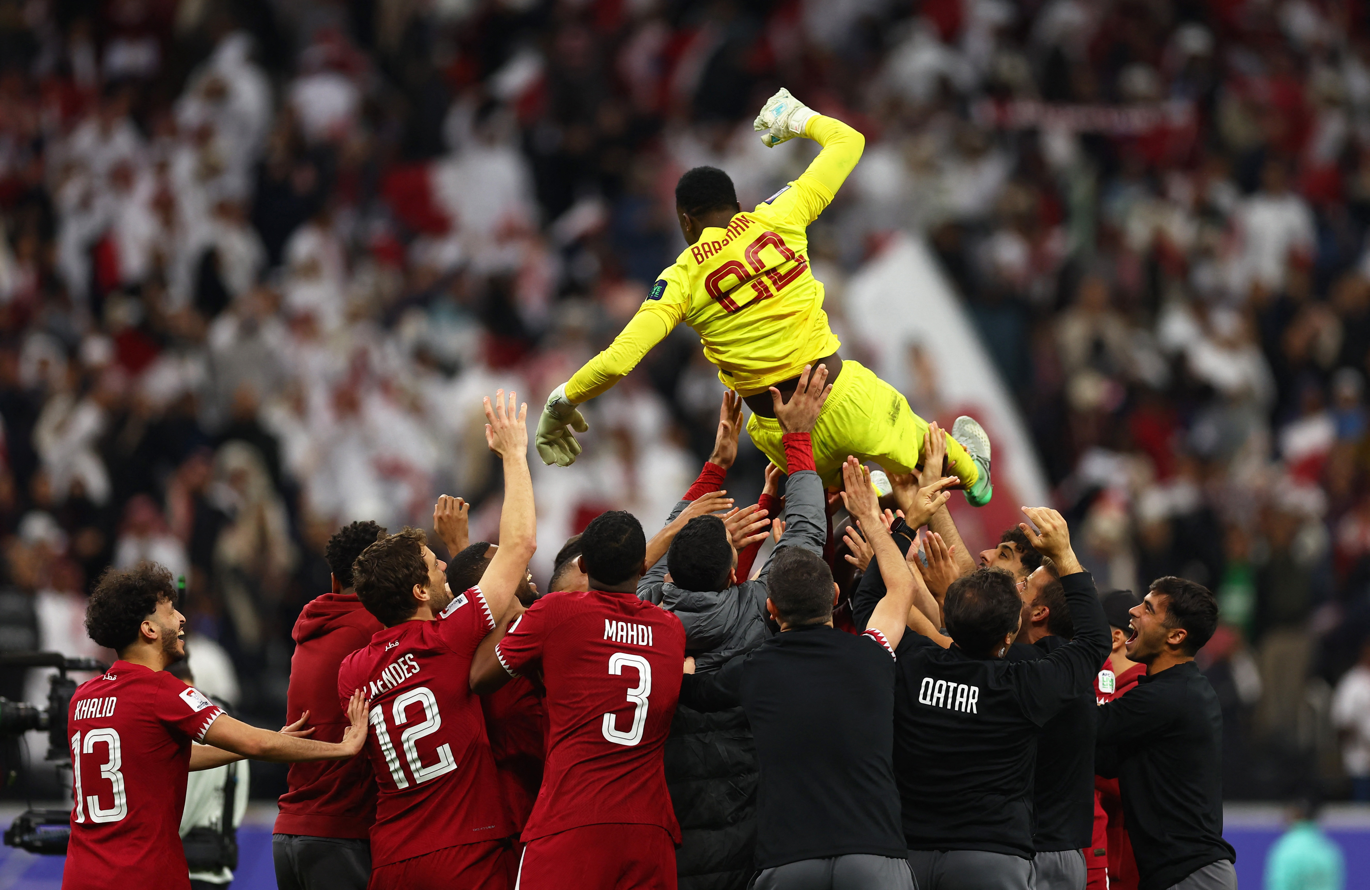 Soccer Football - AFC Asian Cup - Quarter Final - Qatar v Uzbekistan - Al Bayt Stadium, Al Khor, Qatar - February 3, 2024 Qatar's Meshaal Barsham celebrates with teammates after the match REUTERS/Molly Darlington