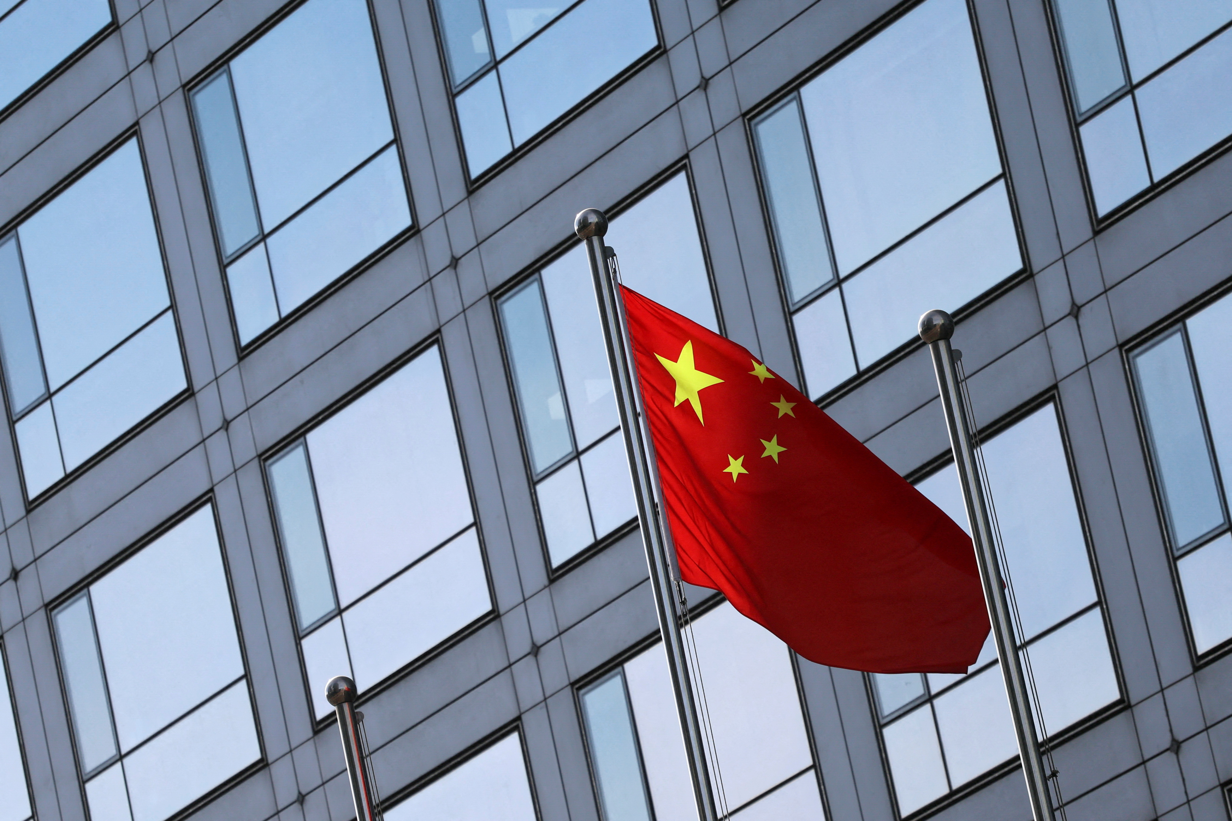 A Chinese flag flutters outside the China Securities Regulatory Commission building.