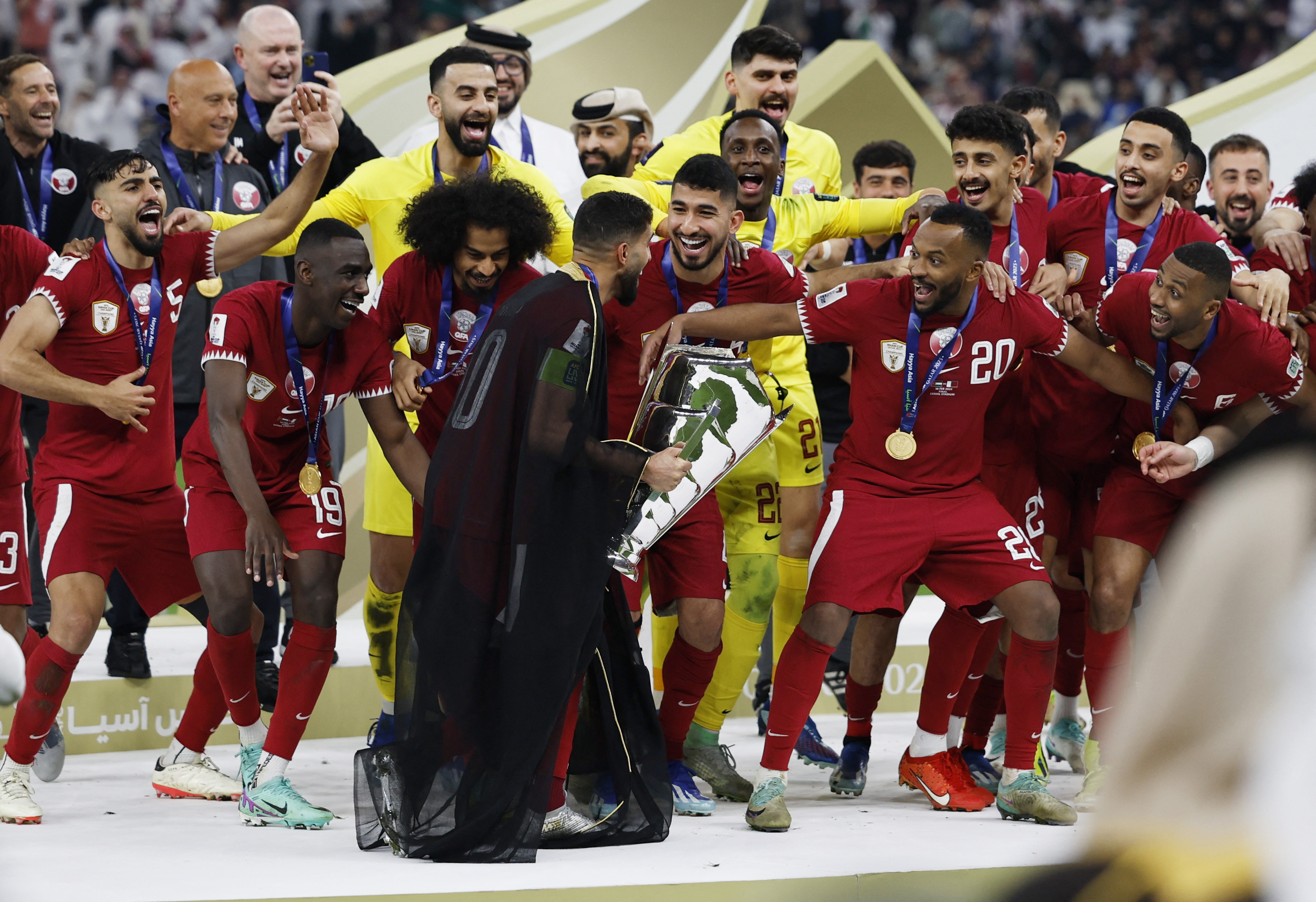Soccer Football - AFC Asian Cup - Final - Jordan v Qatar - Lusail Stadium, Lusail, Qatar - February 10, 2024 Qatar's Hassan Al-Haydos lifts the trophy with teammates after winning the AFC Asian Cup REUTERS/Thaier Al-Sudani
