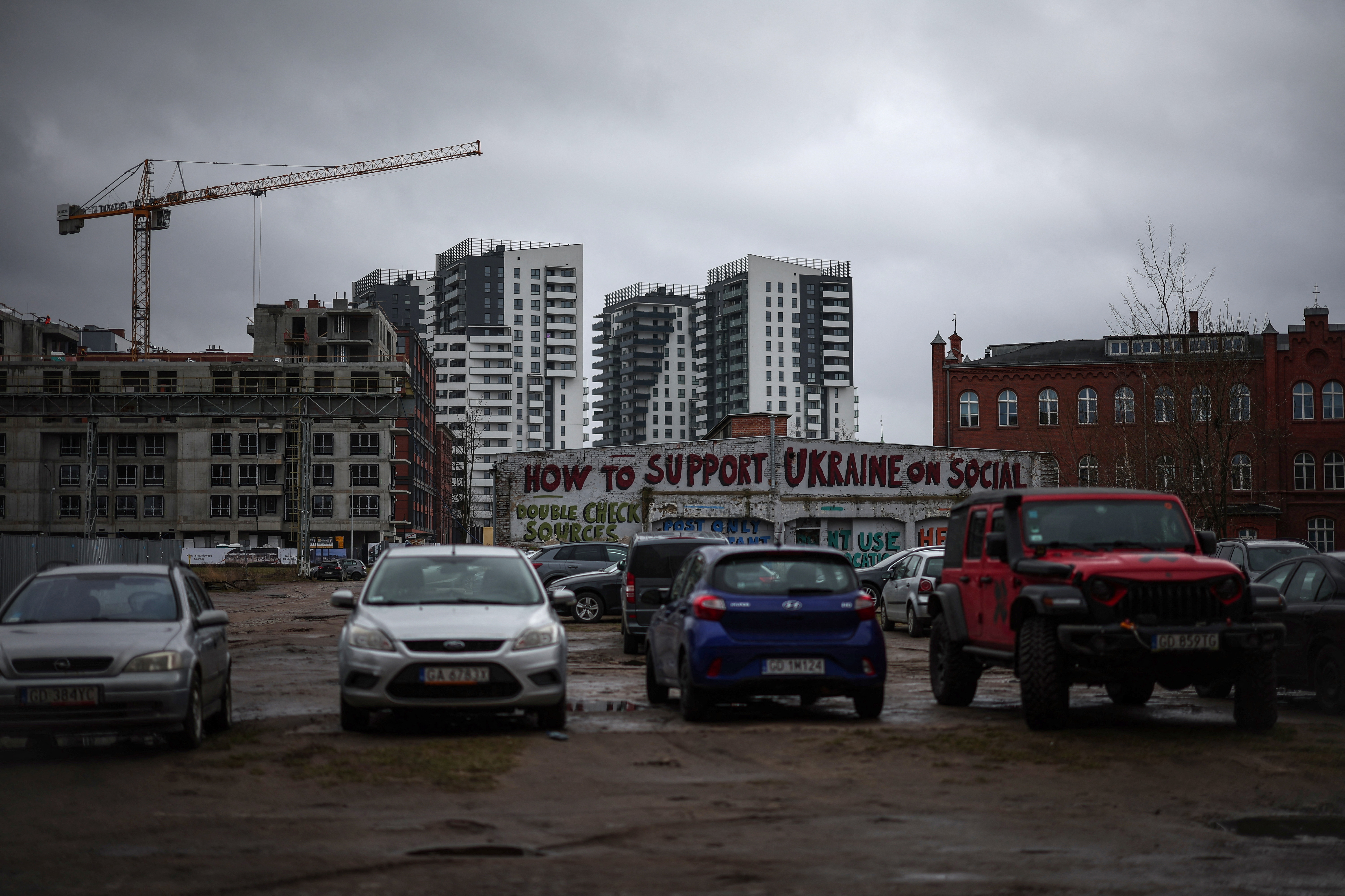 Graffiti reading 'How to support Ukraine on social', is seen at the former shipyard area in Gdansk, Poland