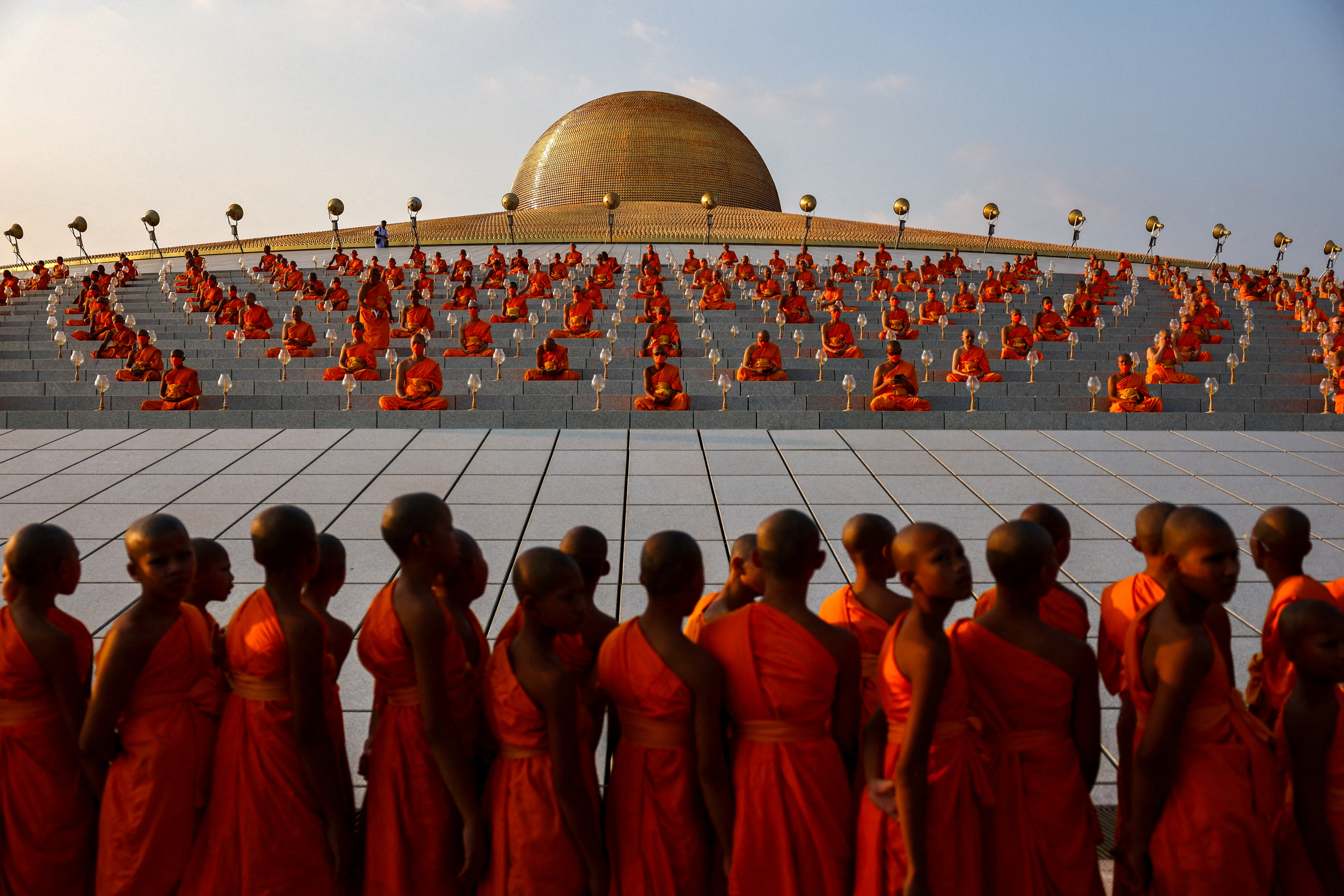 Buddhist monks pray at the Wat Phra Dhammakaya temple during a ceremony commemorating Makha Bucha Day in Pathum Thani province outside Bangkok, Thailand, February 24