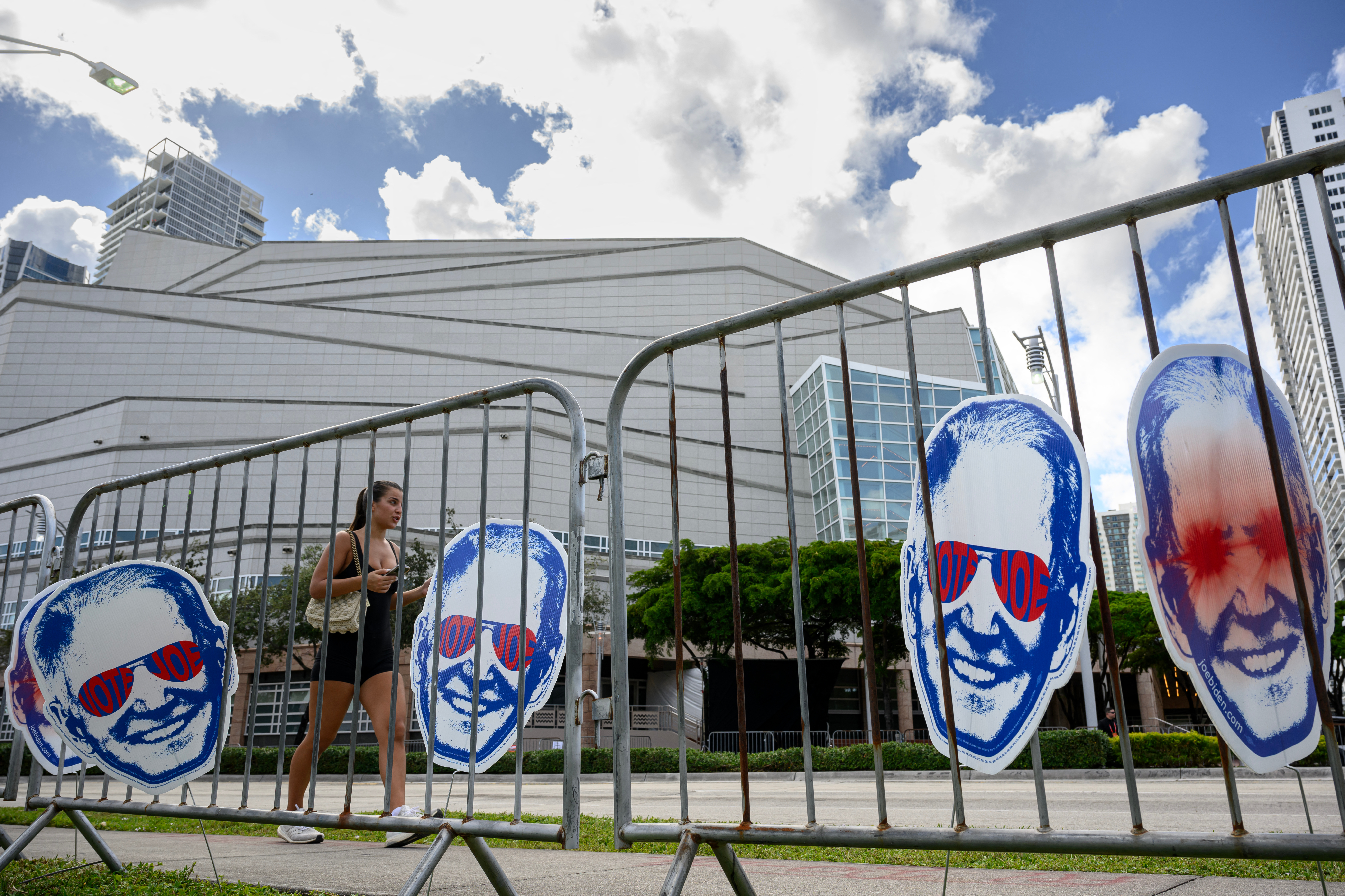 Cut-outs of the "Dark Brandon" internet meme are displayed across from the Adrienne Arsht Center for the Performing Arts, the venue for the third Republican presidential primary debate in Miami