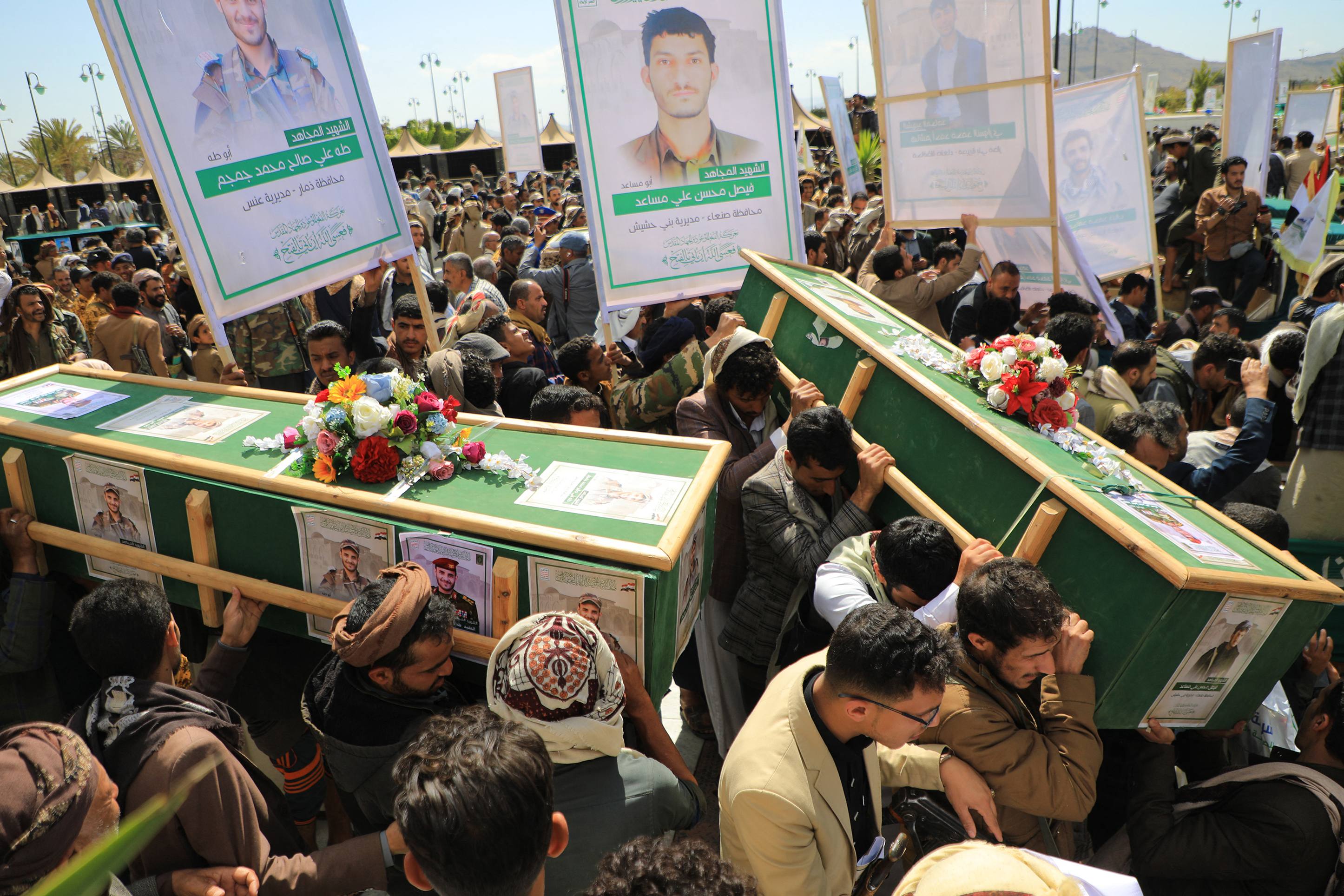 People carry the coffins of Huthi rebels who were killed in recent US-led strikes, ahead of a funeral ceremony in Sanaa's Al-Saleh mosque, on February 10, 2024. - The United States military confirmed on February 8 its forces conducted multiple strikes against Huthi missile systems as the Yemen-based rebel group prepared to launch attacks that threatened US Navy and merchant ships. (Photo by MOHAMMED HUWAIS / AFP)