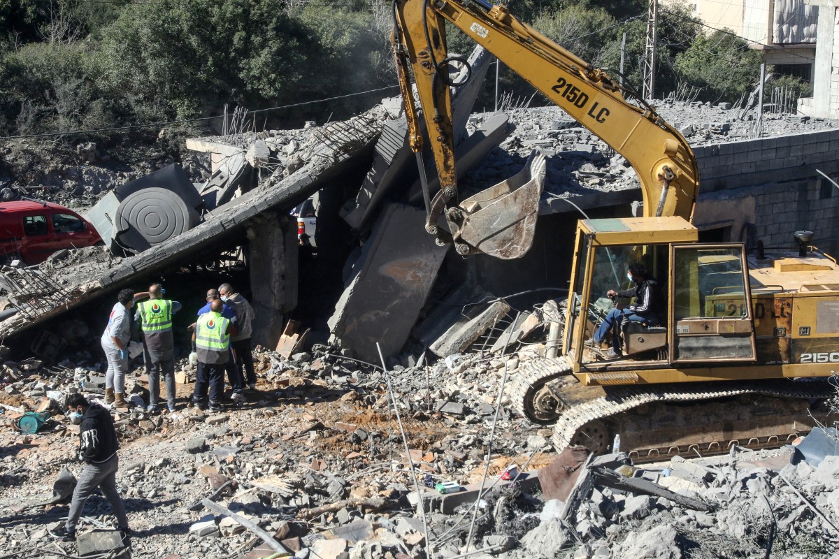 Residents and rescuers check the destruction after an overnight Israeli bombardment in the southern Lebanese village of Kafra