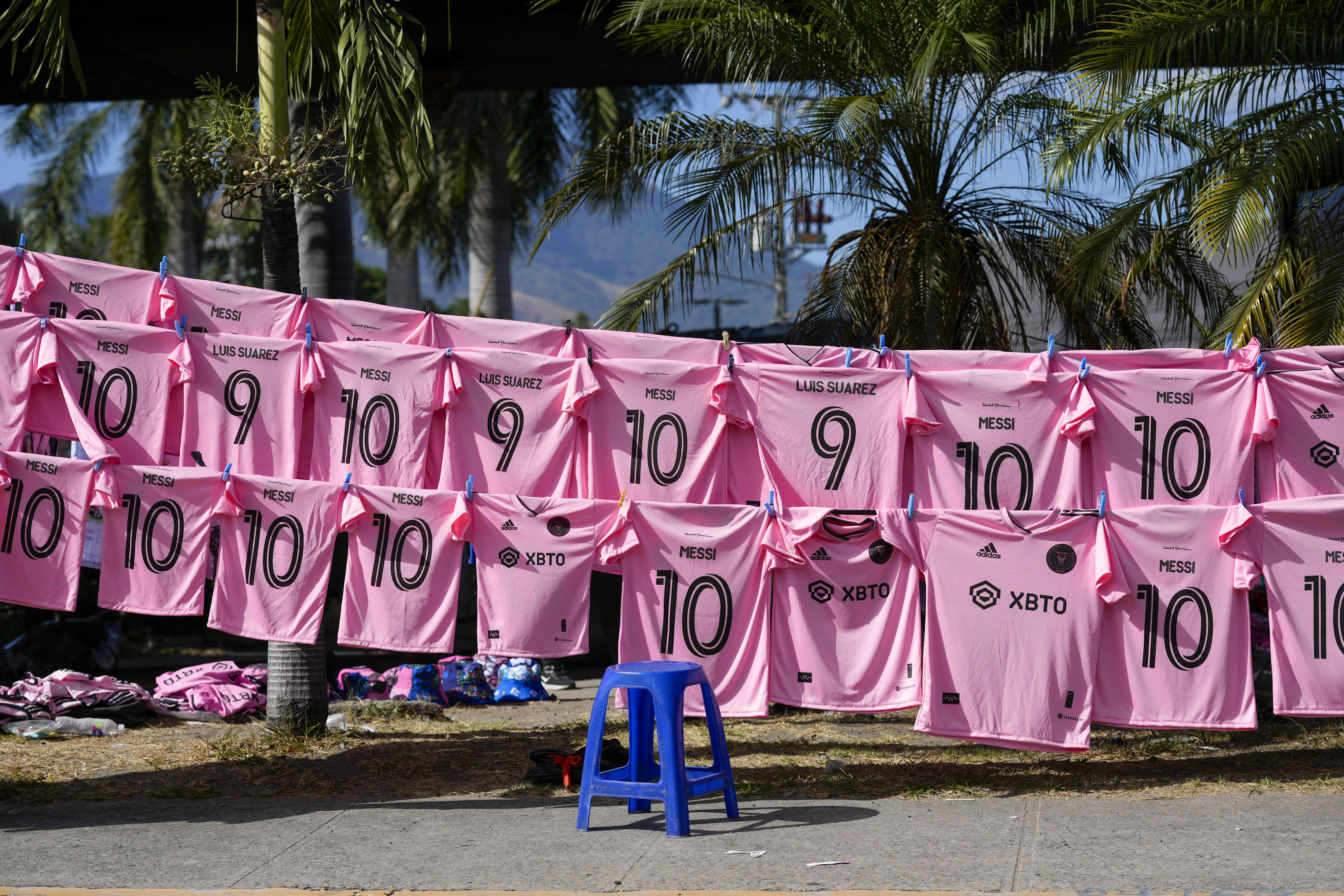 Jerseys of Inter Miami's Lionel Messi and Luis Suarez are displayed for sale outside the Cuscatlan stadium prior to a friendly soccer match between El Salvador's national team and Inter Miami, in San Salvador, El Salvador, Friday, Jan. 19, 2024. (AP Photo/Moises Castillo)