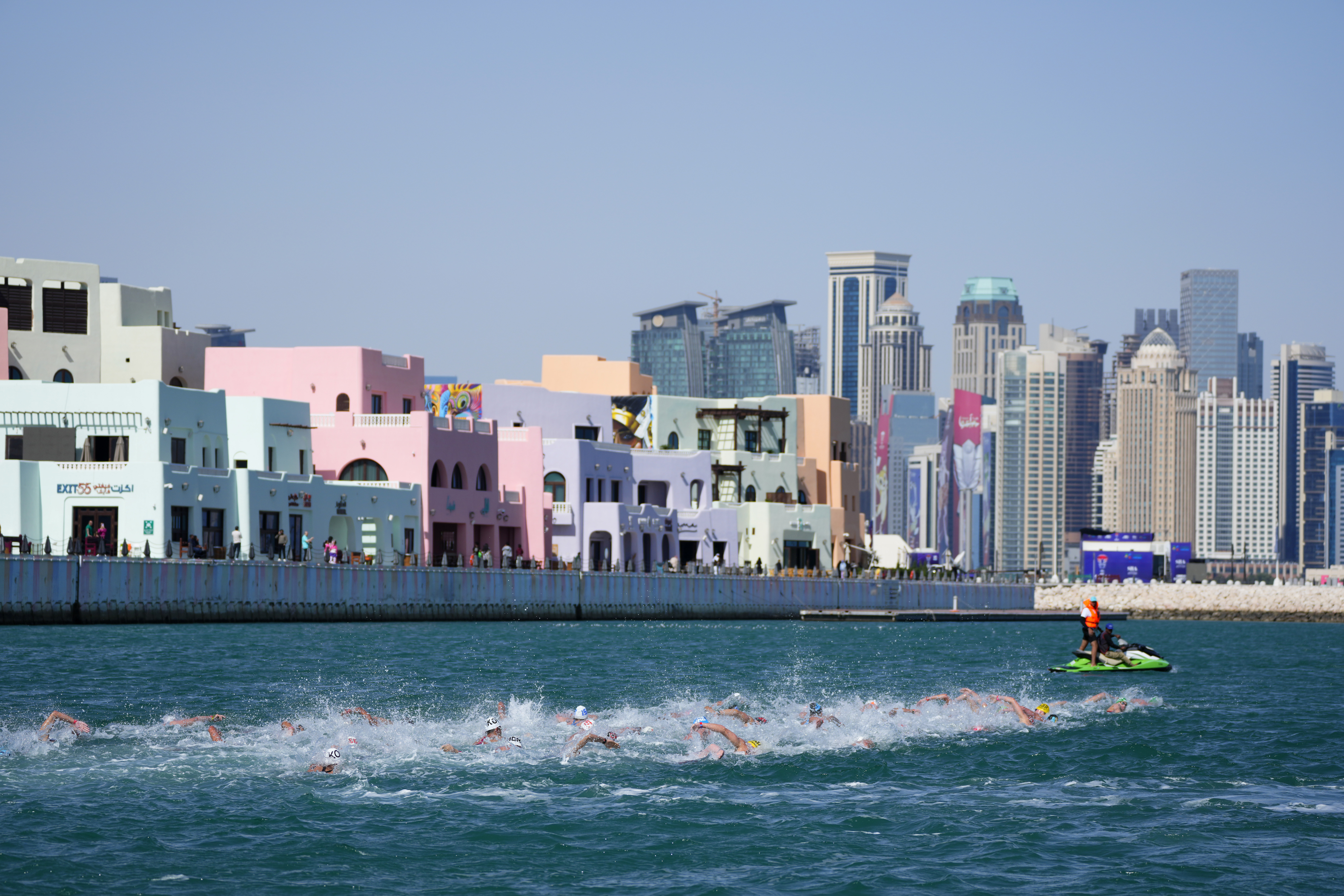 Athletes compete in the men's 10 km open water final at the World Aquatics Championships in Doha, Qatar, Sunday