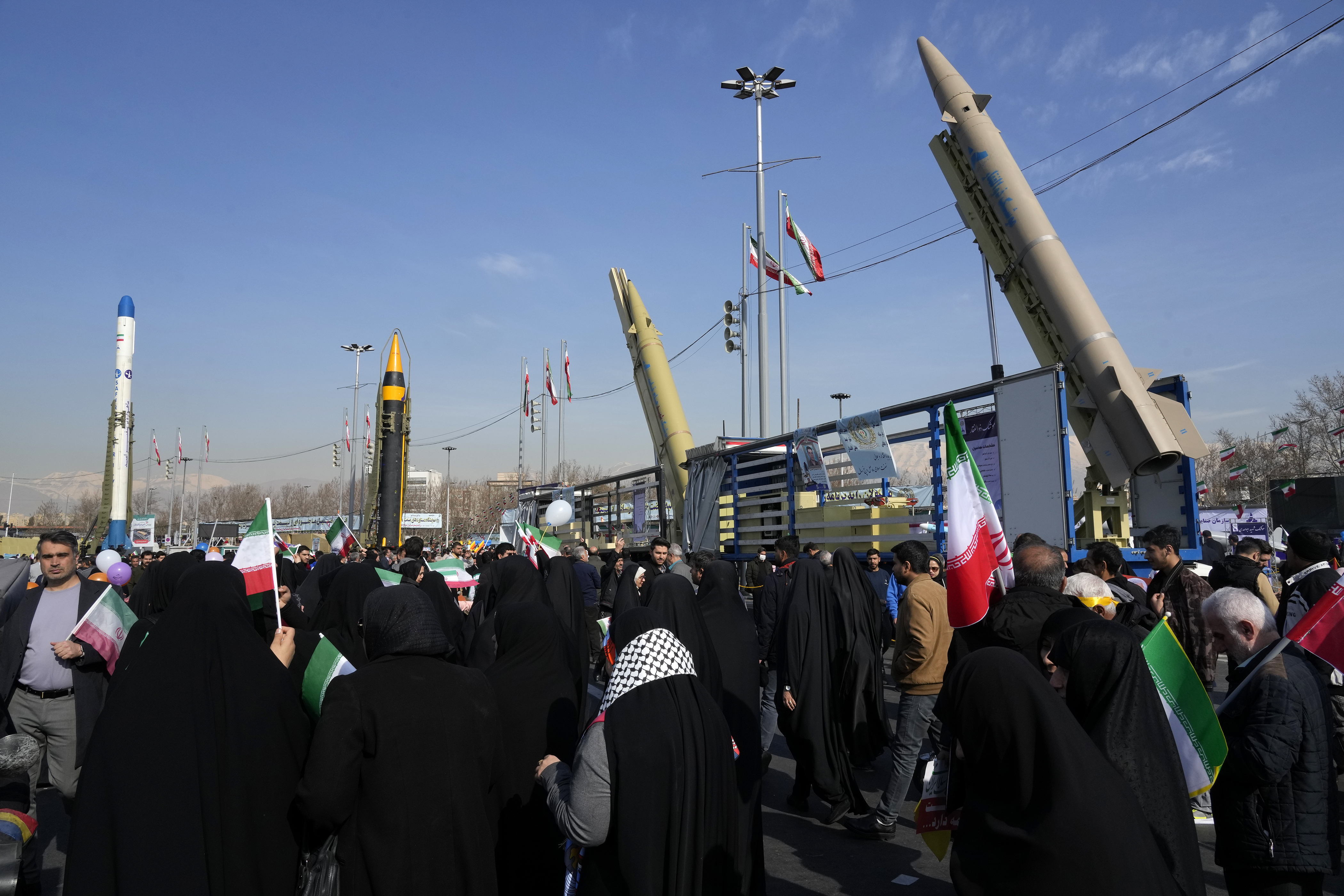 Iranians attend the annual rally commemorating their 1979 Islamic Revolution as domestically-built missiles and a satellite carrier are displayed at the Azadi (Freedom) Sq. in in Tehran