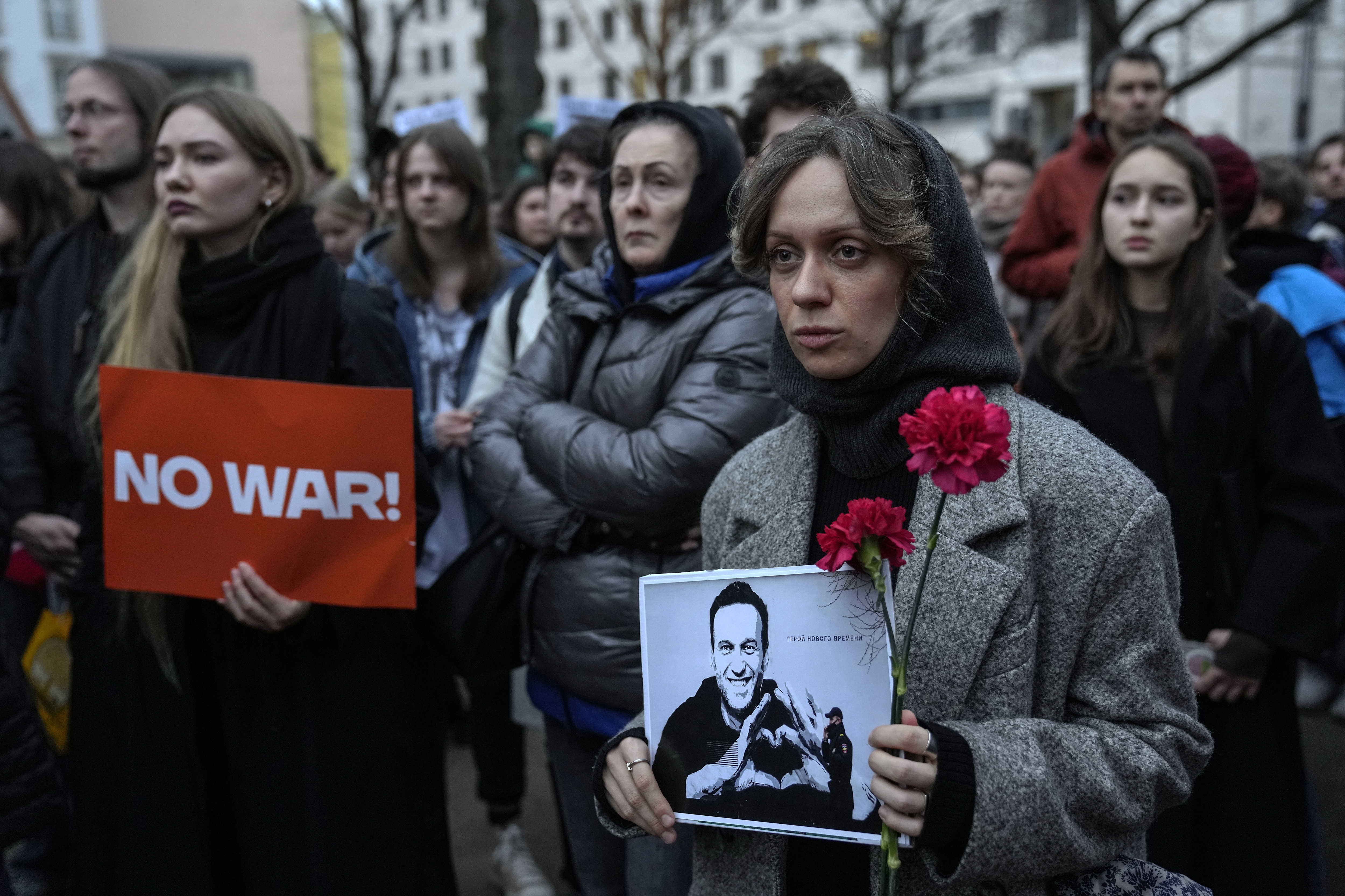 A woman holds a portrait of jailed Russian opposition leader Alexei Navalny during a protest in front of the Russian embassy in Berlin, Germany, Friday, Feb. 16