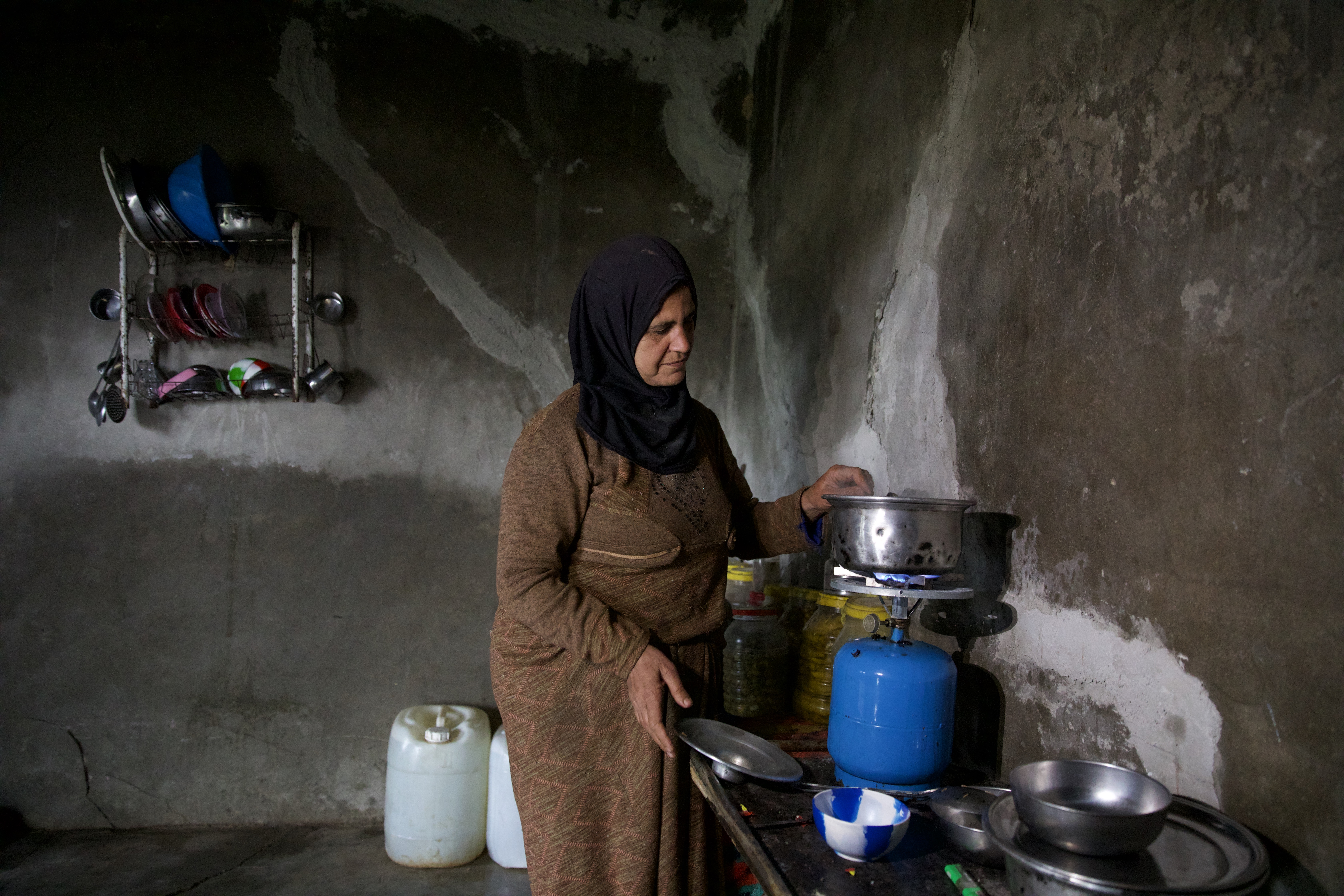 After spending a lot of money on repairing the house, Abdul Karim’s wife was able to use her kitchen to a limited extent to cook food and move it to the tent where her family resides.