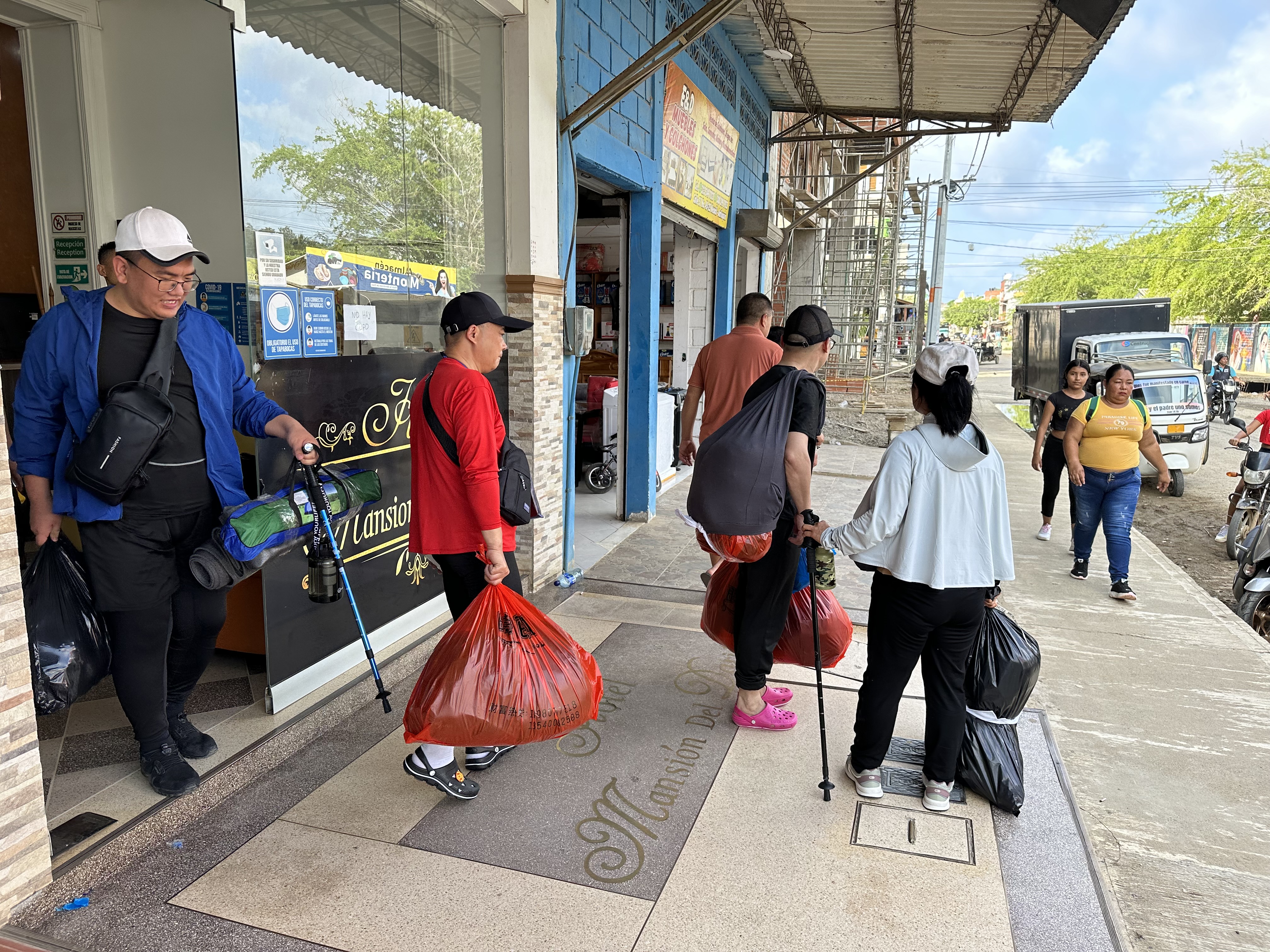 Chinese migrants in trekking gear-