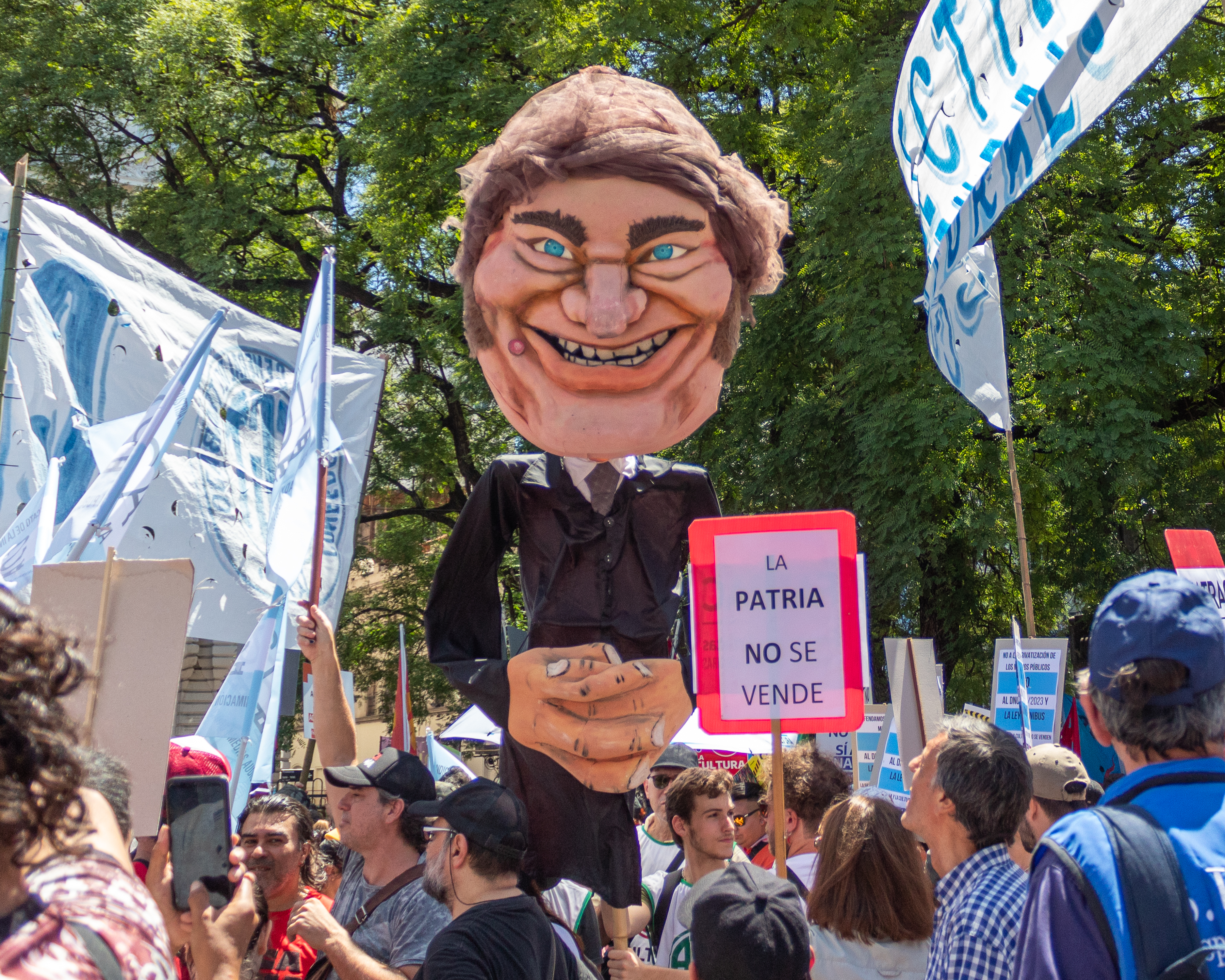 Protesters in Argentina carry aloft an effigy of President Javier Milei