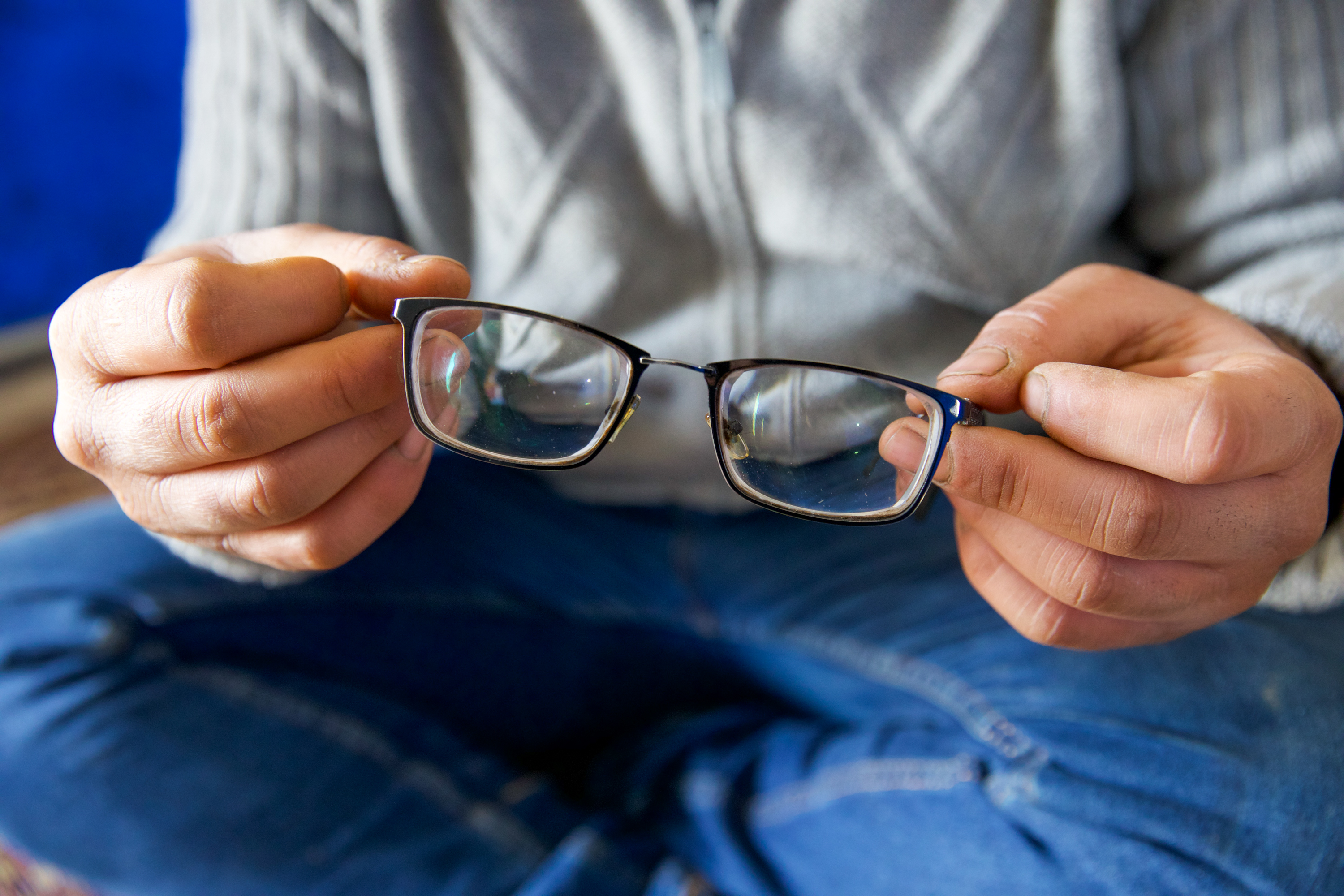 Ibrahim's hands holding his glasses