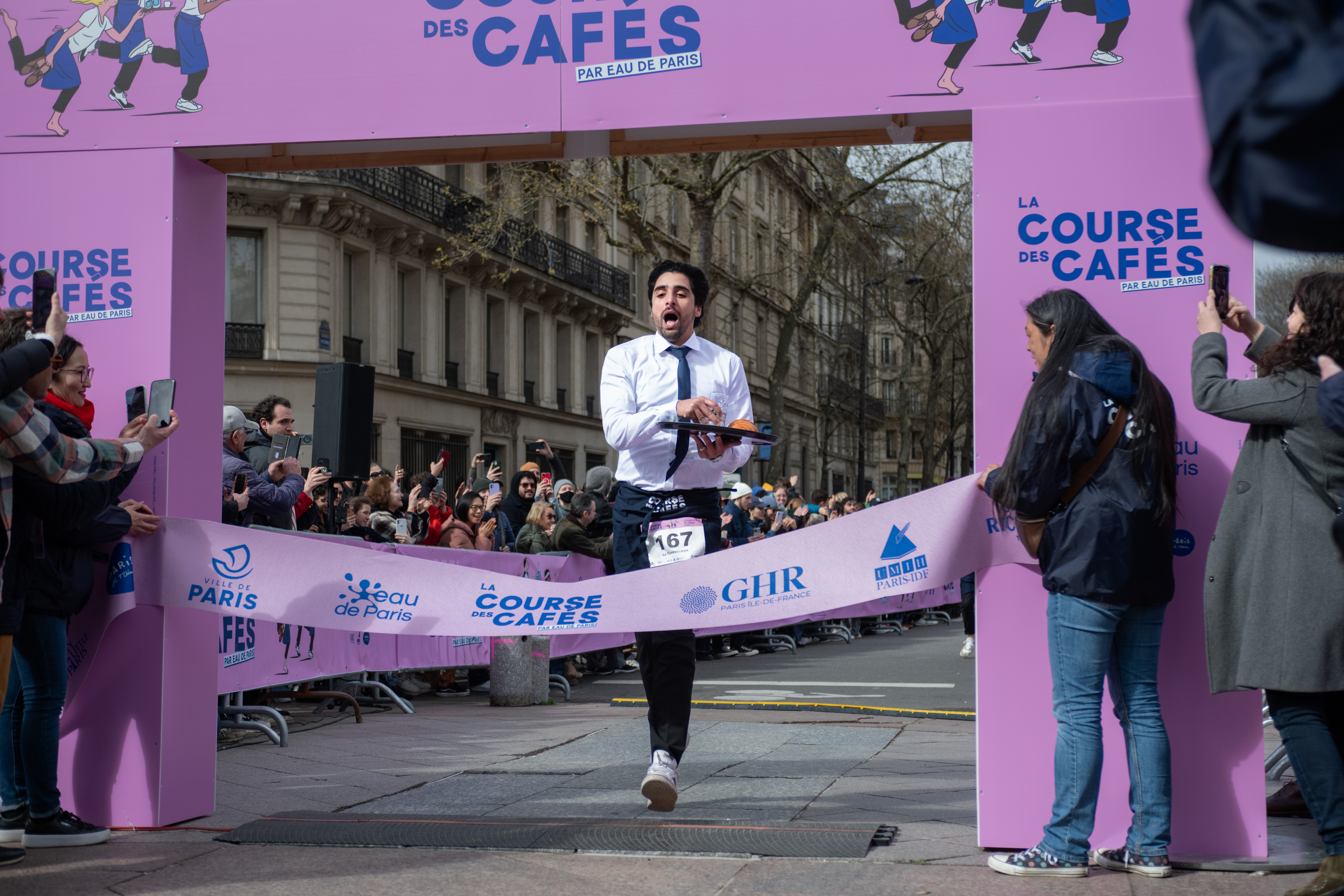 Samy Lamrous of La Contrescarpe, a cafe in the Latin Quarter, crosses the finish line. Lamrous was the top men’s finisher.