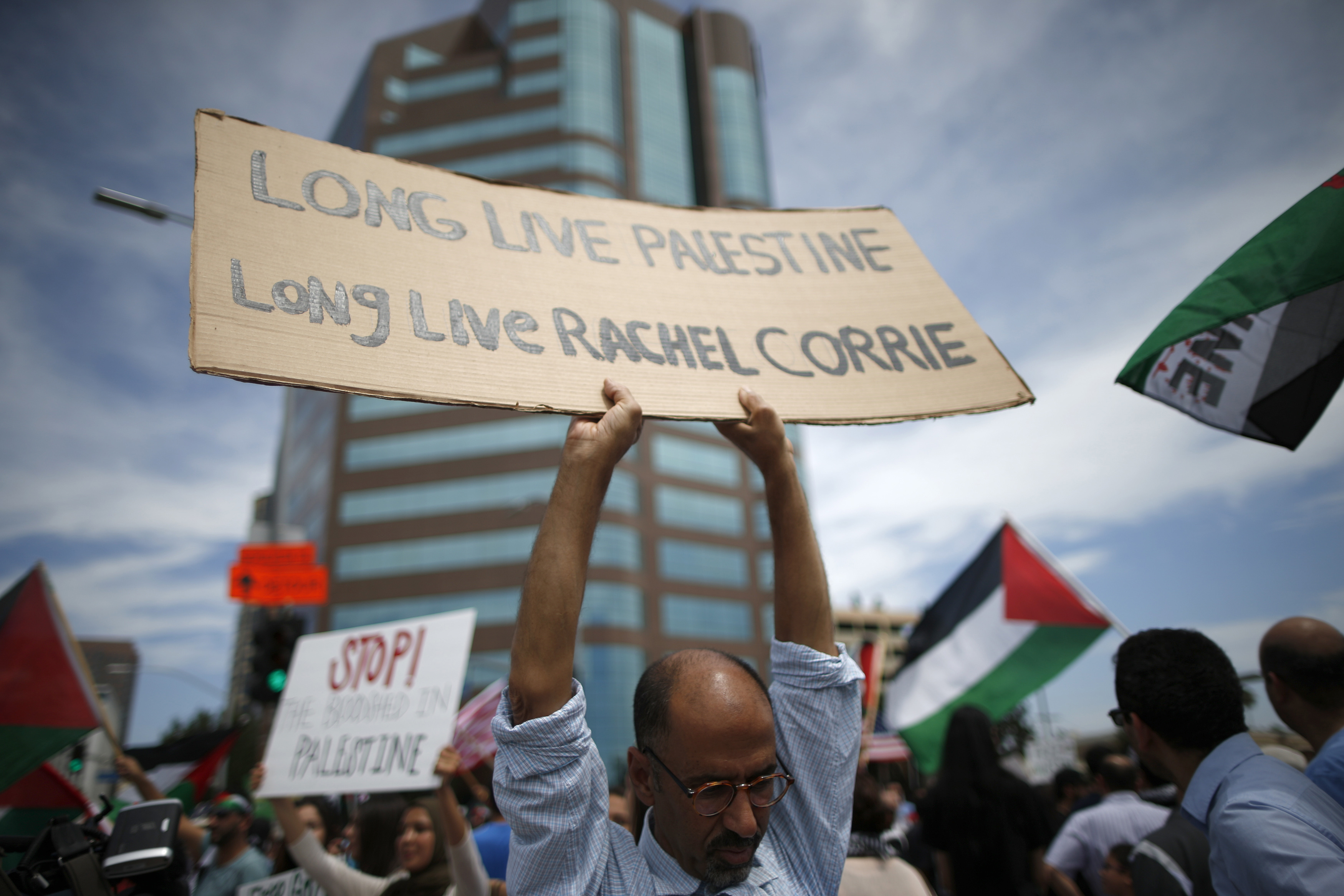 A man holds up a sign during a "Muslims in solidarity with Palestinians in Gaza" rally in front of the Federal Building in Los Angeles, California