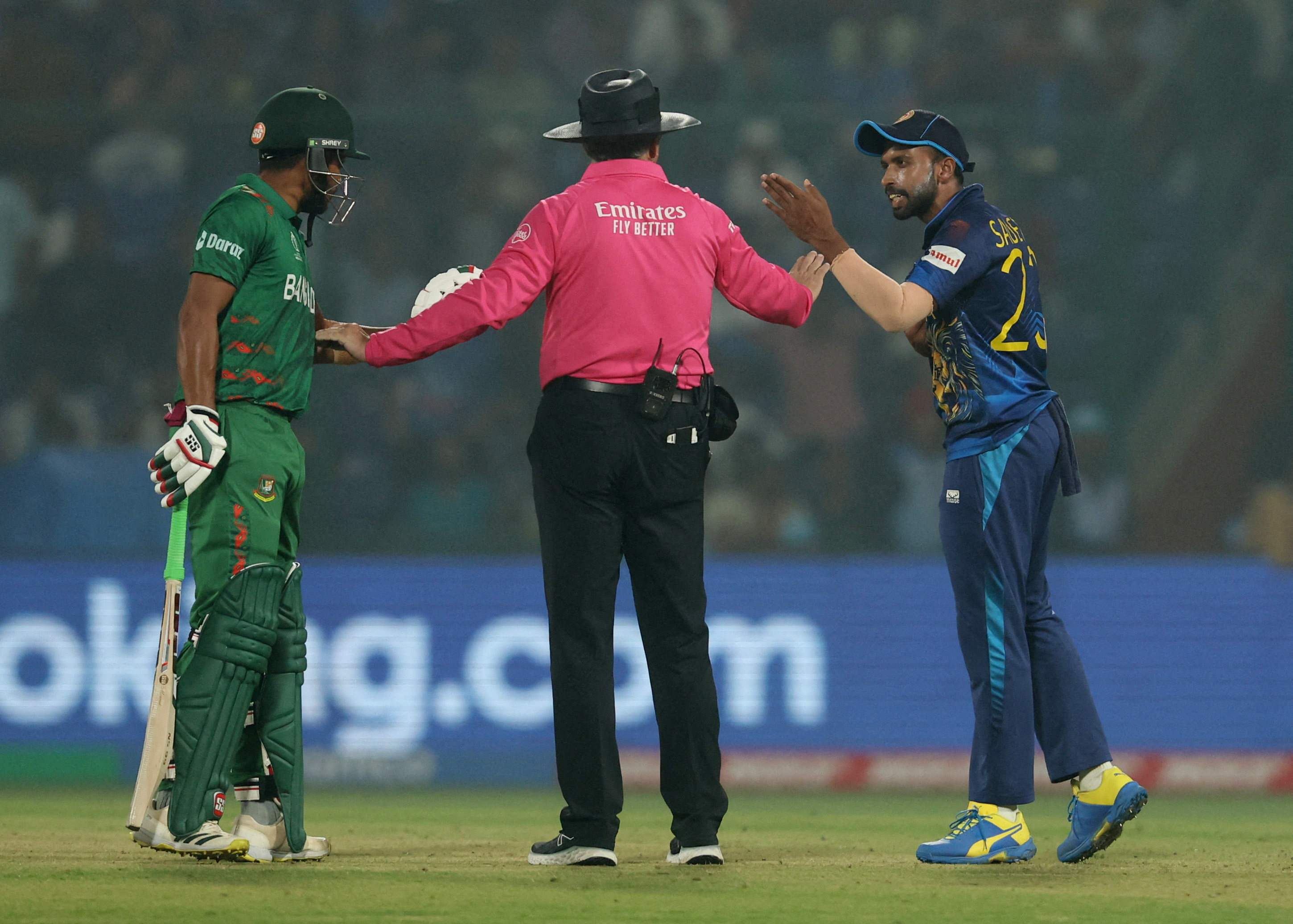 Cricket - ICC Cricket World Cup 2023 - Bangladesh v Sri Lanka - Arun Jaitley Stadium, New Delhi, India - November 6, 2023 Umpire attempts to stop an argument between Bangladesh's Najmul Hossain Shanto and Sri Lanka's Sadeera Samarawickrama REUTERS/Anushree Fadnavis