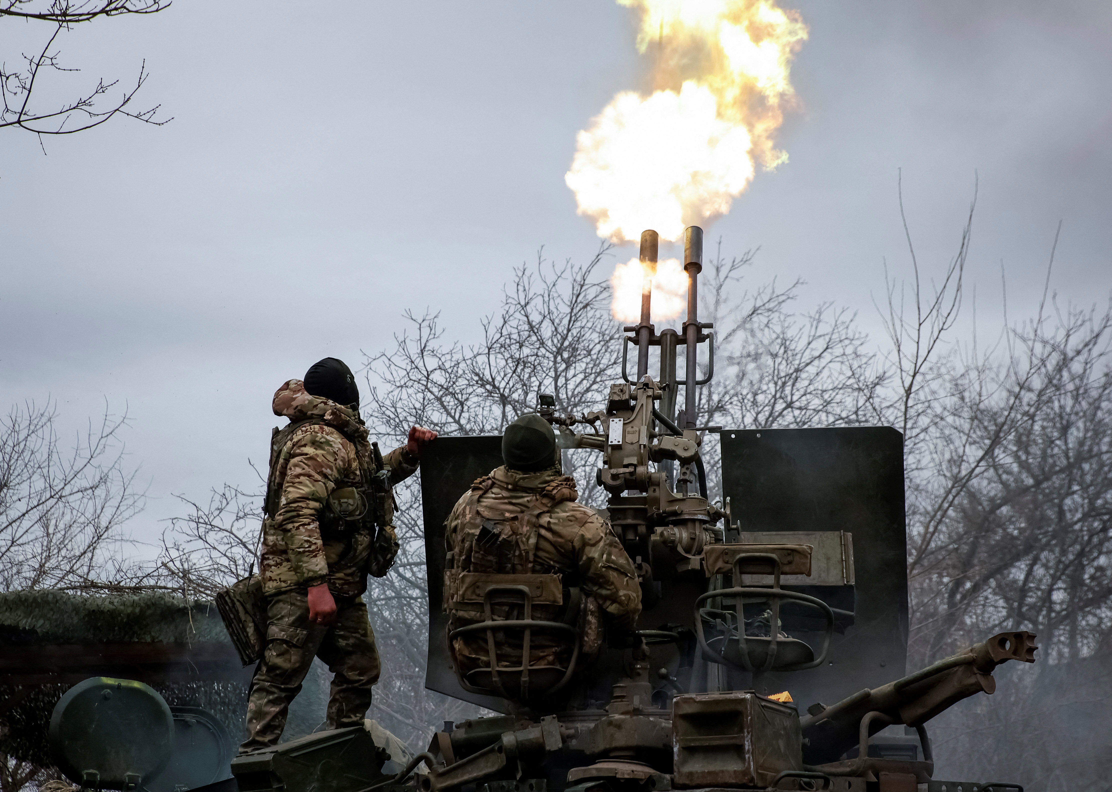 Ukrainian servicemen from air defence unit of the 93rd Mechanized Brigade fire an anti aircraft cannon at a frontline