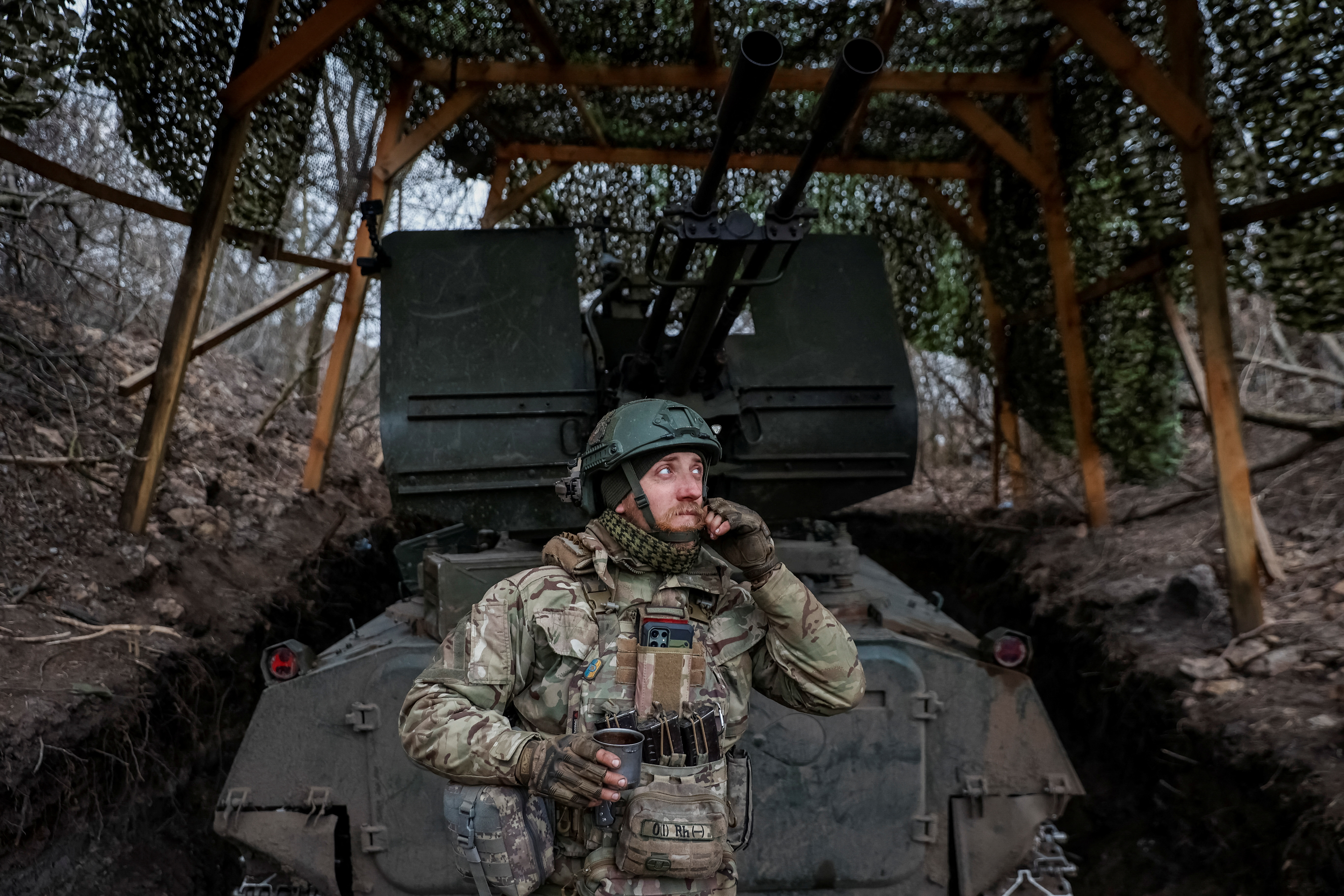 A Ukrainian serviceman from air defence unit of the 93rd Mechanized Brigade stands near an anti aircraft cannon at a frontline, amid Russia's attack on Ukraine, near the town of Bakhmut, Ukraine March 6, 2024. Radio Free Europe/Radio Liberty/Serhii Nuzhnenko via REUTERS