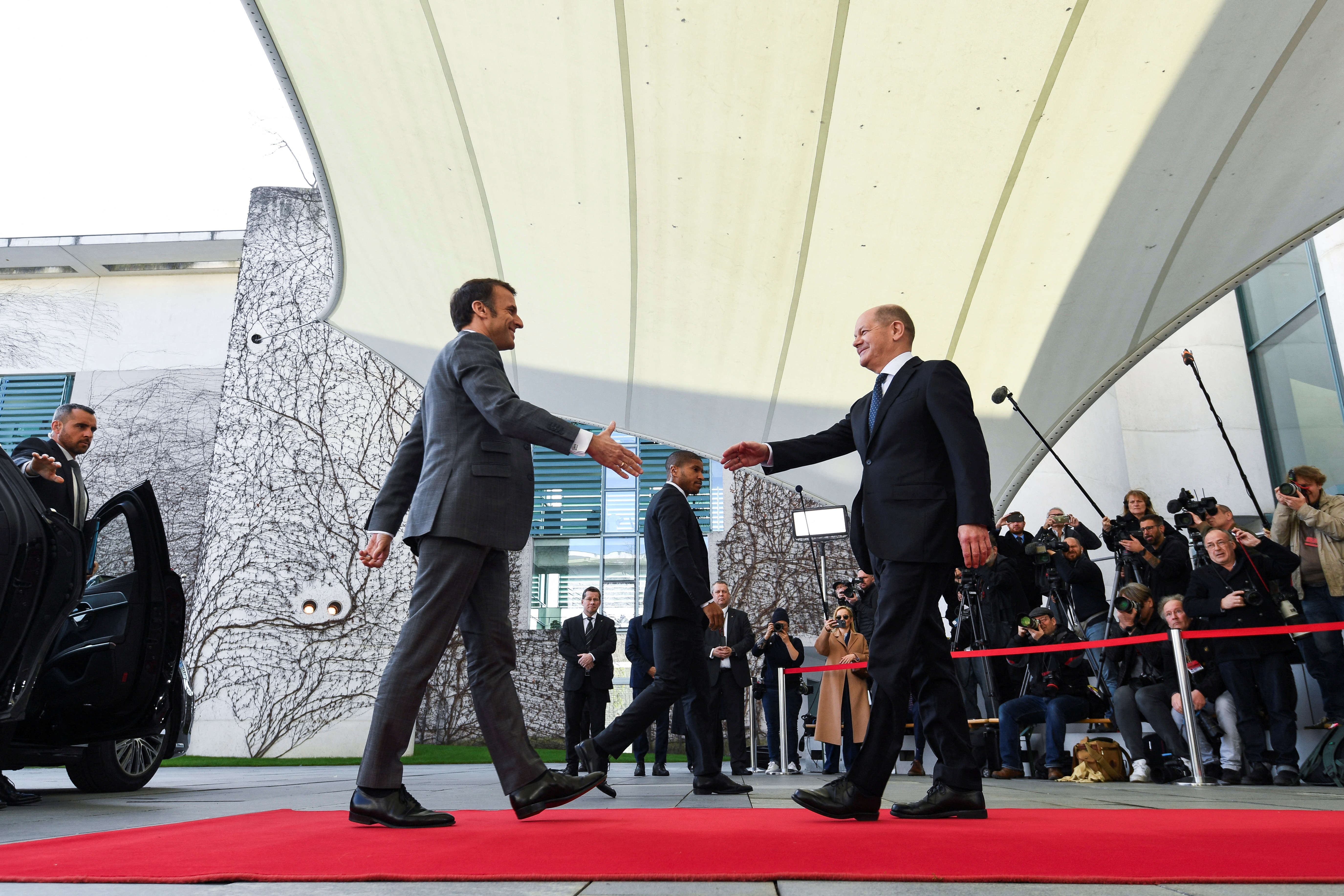 German Chancellor Olaf Scholz welcomes French President Emmanuel Macron before their trilateral meeting with Polish Prime Minister Donald Tusk