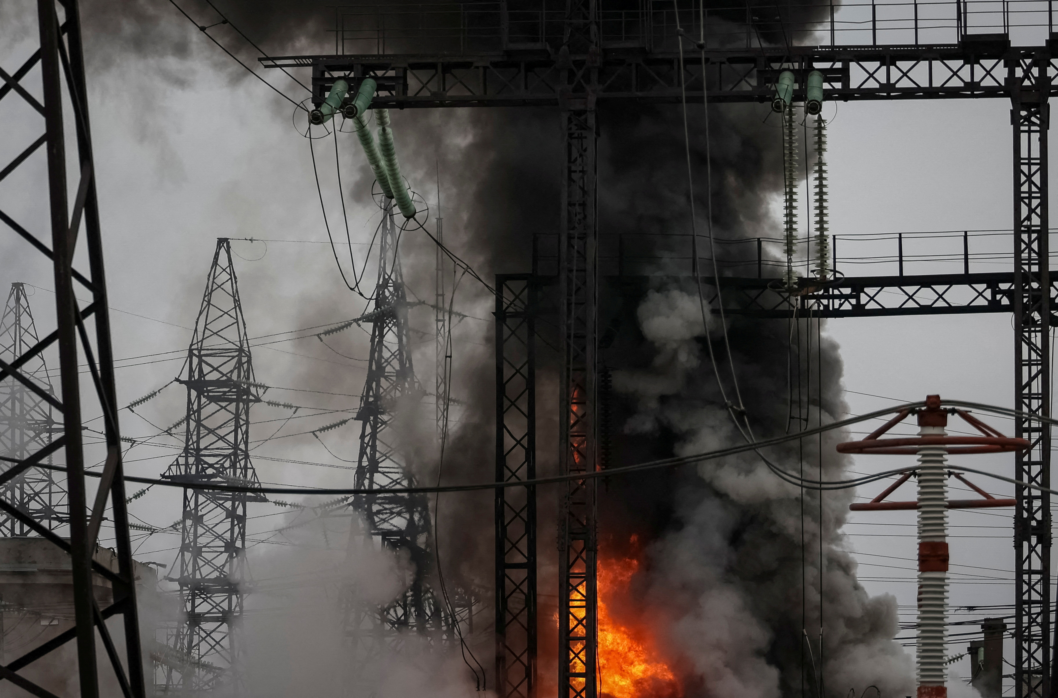 Smoke and fire are seen near a high-voltage line at a site of a Russian missile strike, amid Russia's attack on Ukraine, outside Kharkiv, Ukraine March 22, 2024. REUTERS/Sofiia Gatilova TPX IMAGES OF THE DAY