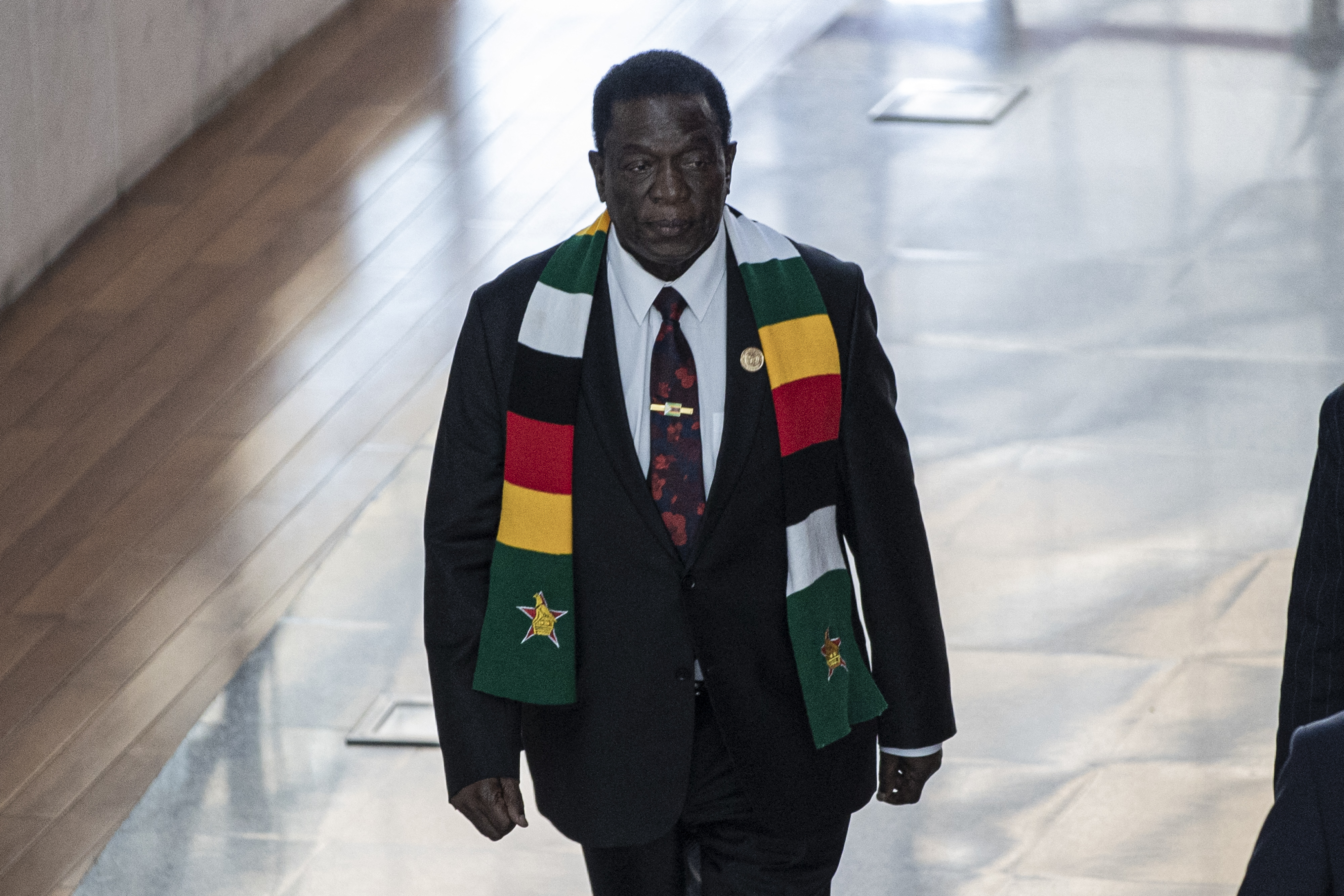 President of Zimbabwe Emmerson Mnangagwa. He is walking along a corridor