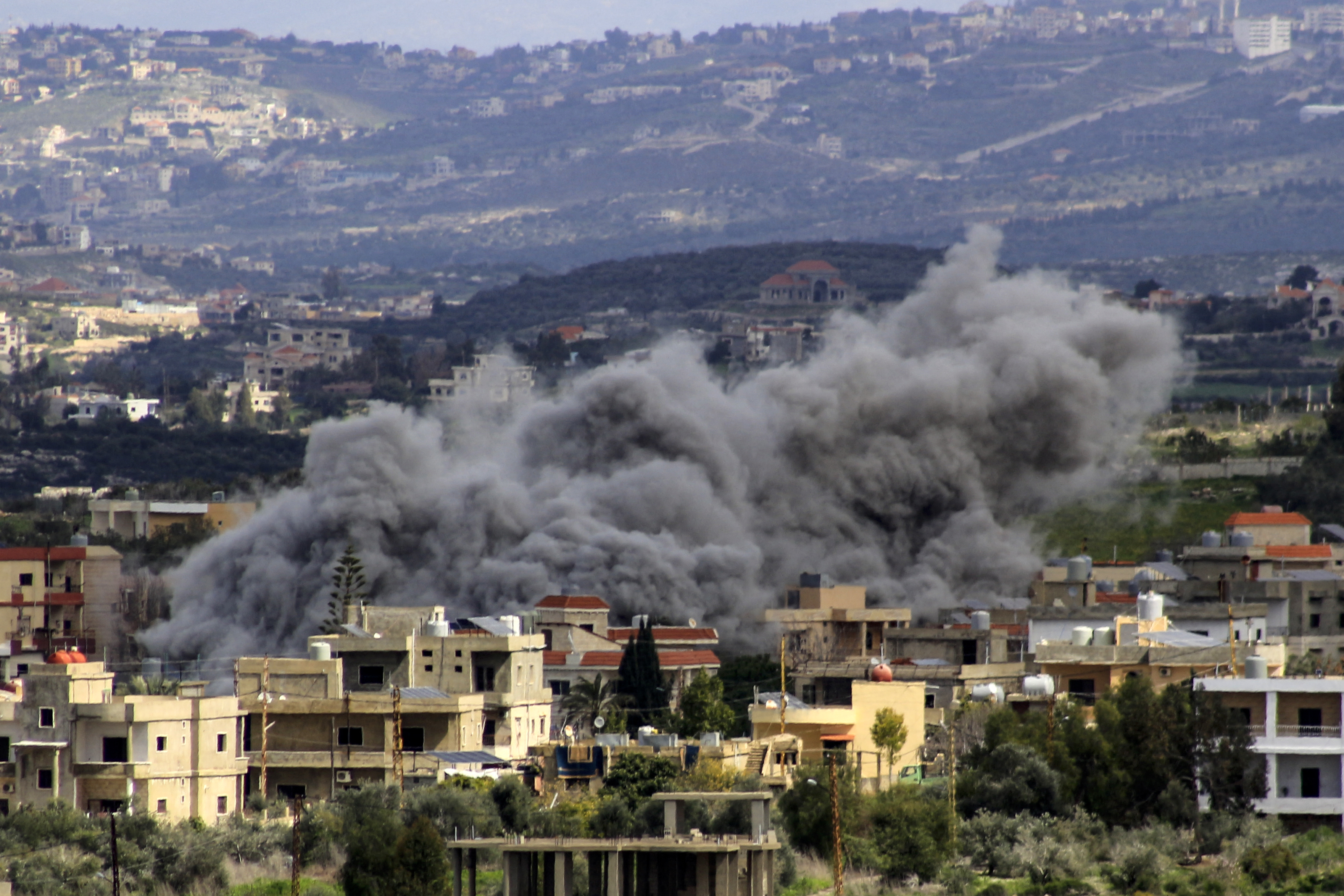 Smoke billows above buildings following an Israeli strike in the southern Lebanese border village of Majdal Zoun on March 9, 2024, amid ongoing cross-border tensions as fighting continues between Israel and Hamas militants in the Gaza Strip. (Photo by AFP)