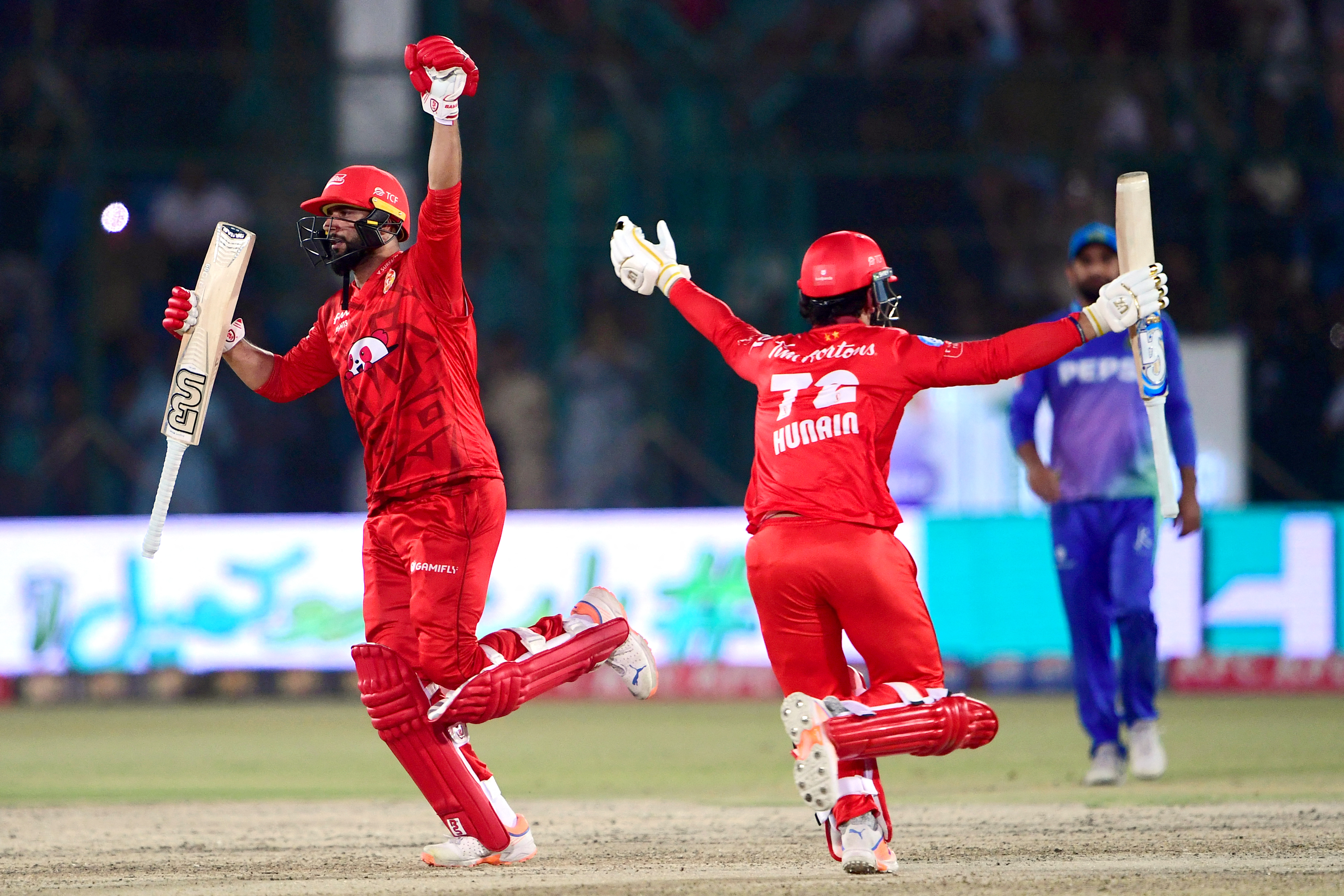 Islamabad United's Hunain Shah (R) and Imad Wasim (L) celebrate scoring the winning runs during the Pakistan Super League (PSL) Twenty20 cricket final match