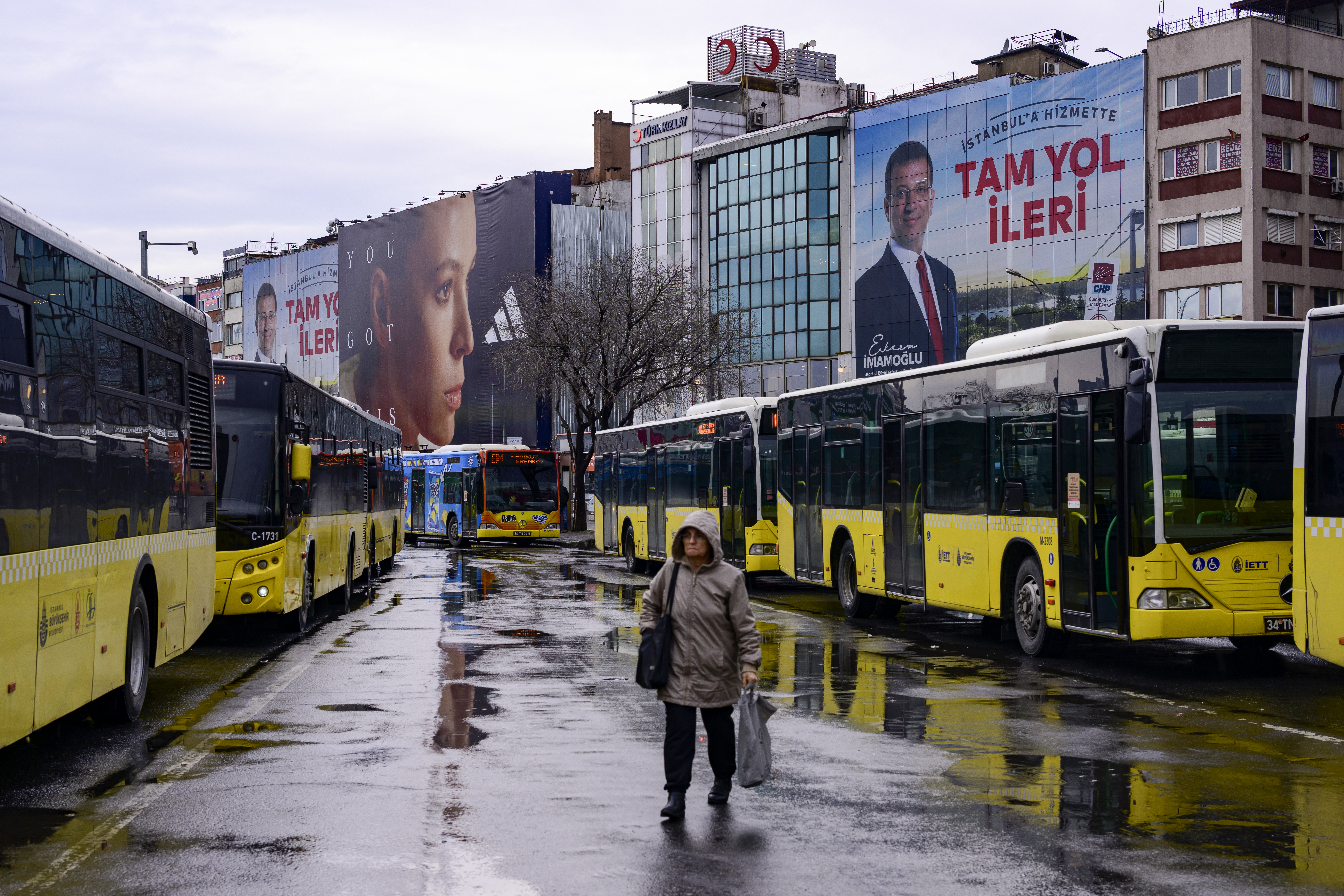 A pedestrian walks past an electoral poster displaying Republican People's Party (CHP) candidate Ekrem Imamoglu in Istanbul on March 25, 2024, ahead of the March 31 municipal elections.