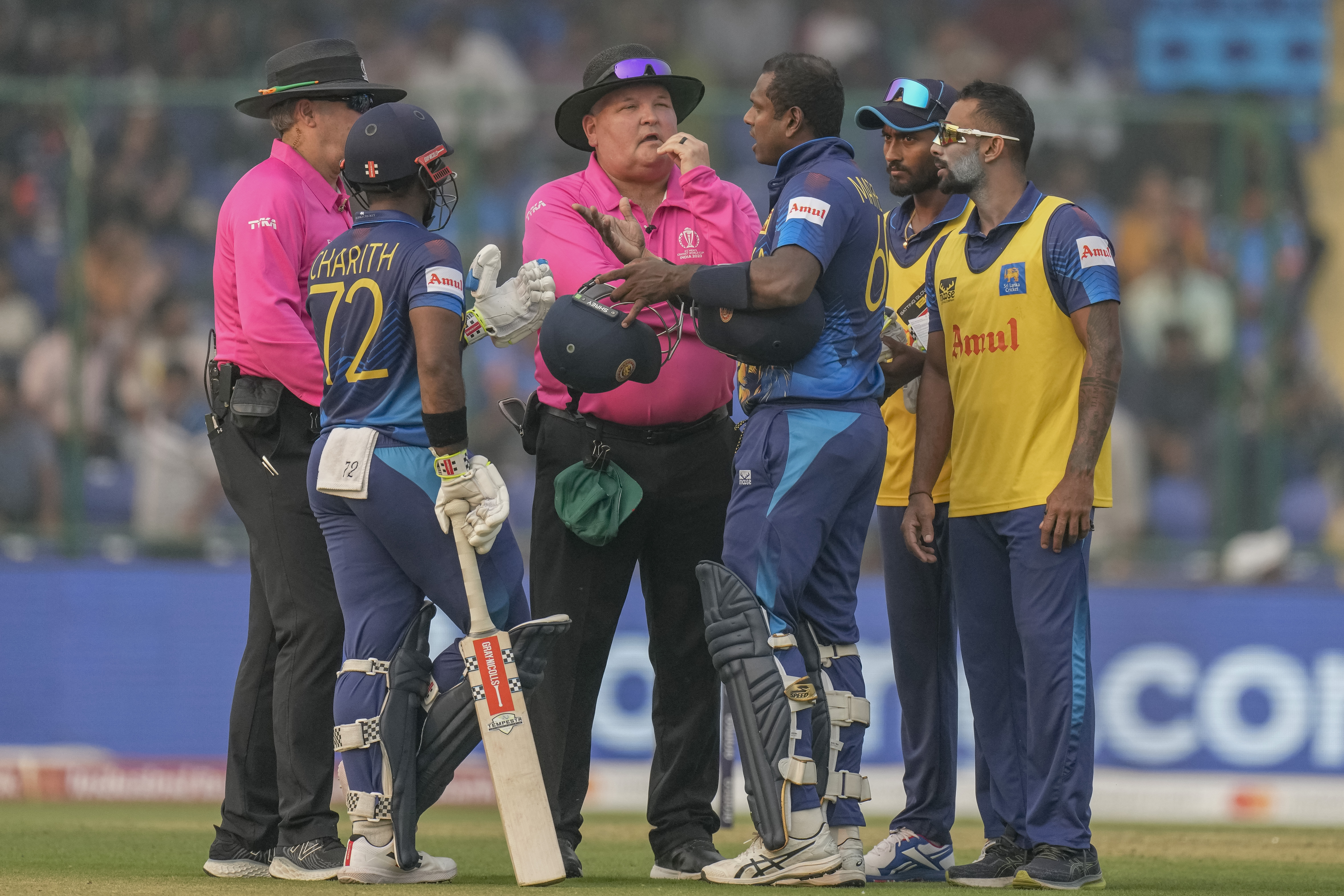 Sri Lanka's Angelo Mathews, third right, talks to umpires after he was declared timed out during the ICC Men's Cricket World Cup match between Bangladesh and Sri Lanka in New Delhi, India, Monday, Nov. 6, 2023. Mathews who wasn’t ready to face his first ball within the stipulated two minutes became the first batter to be timed out in international cricket as the strap of his helmet appeared to be broken and he called for a replacement helmet. (AP Photo/Manish Swarup)