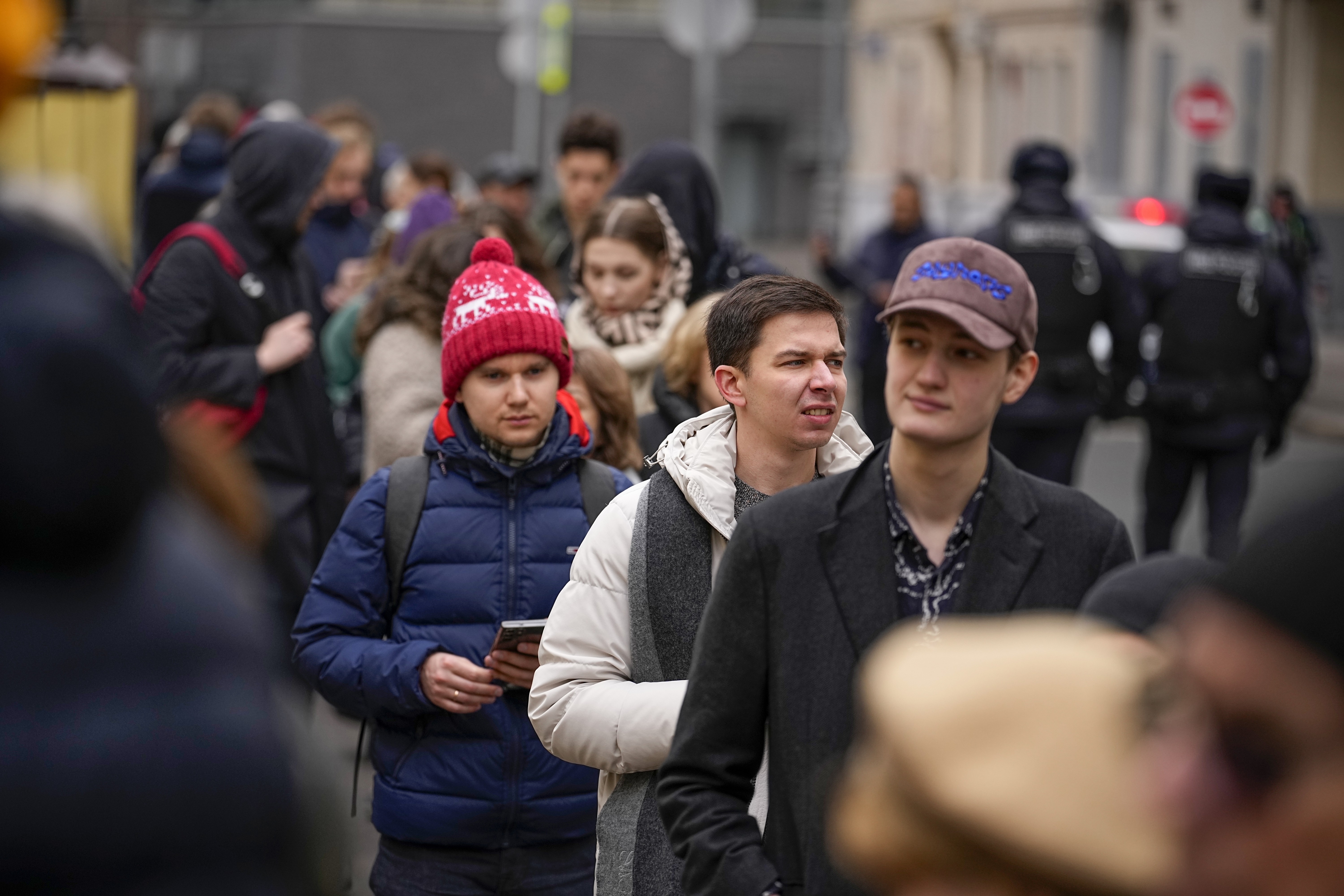 Voters queue at a polling station at noon local time in Moscow, Russia, on Sunday, March 17