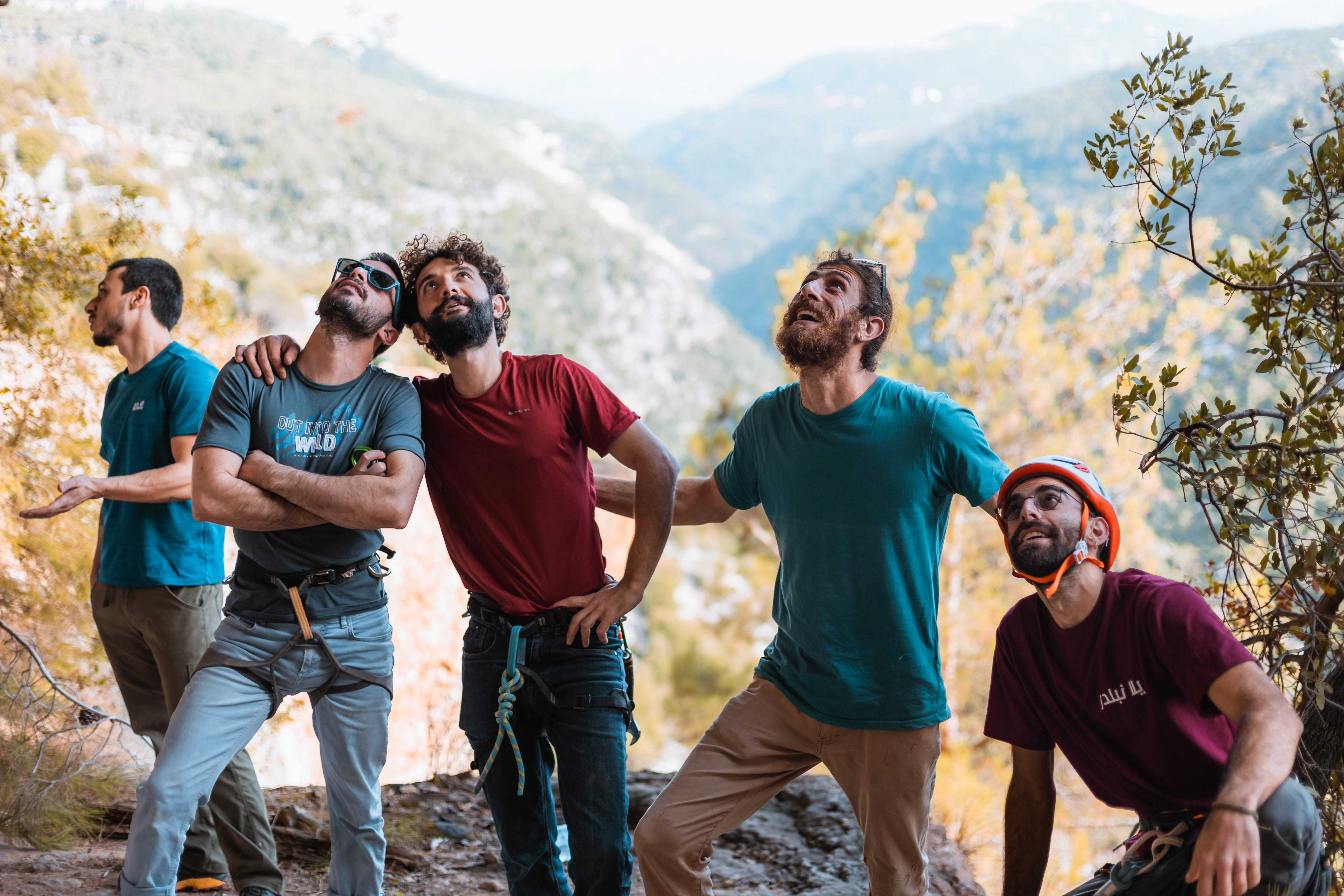 A group look up on a cliff edge