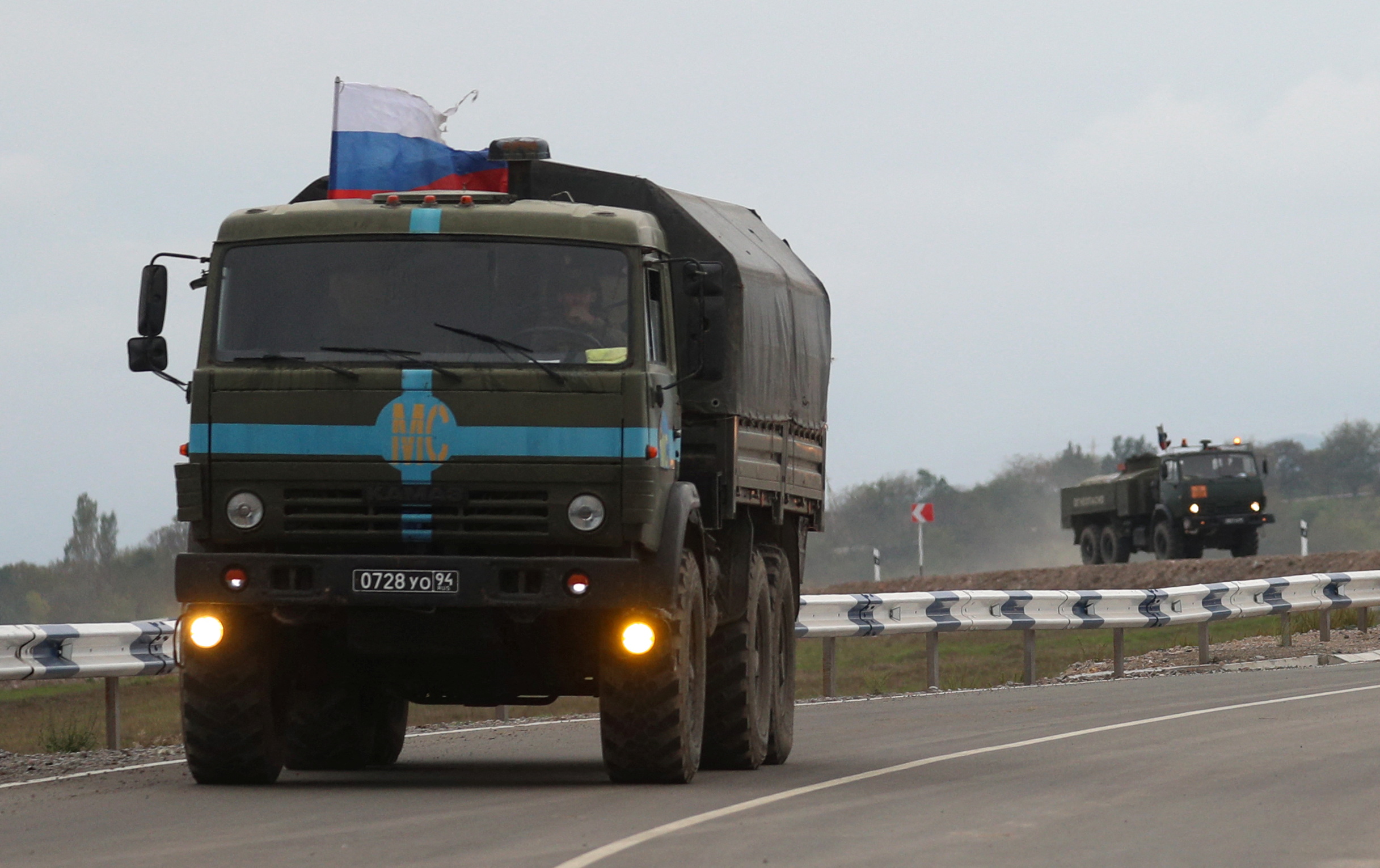 Russian peacekeepers drive trucks in direction towards the Armenia-Azerbaijan border
