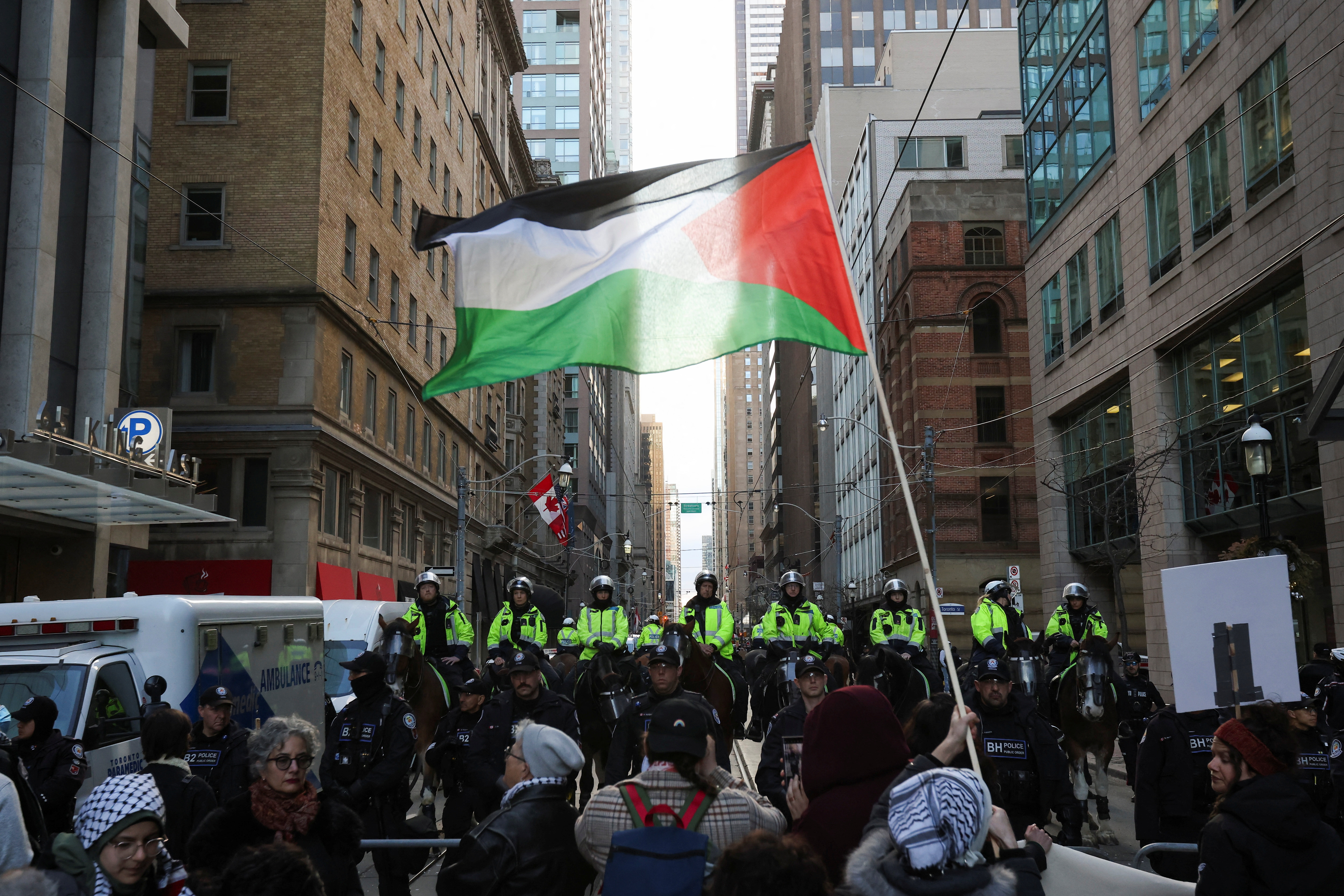 Police officers stand guard as protesters demand a Gaza ceasefire during a rally in Toronto, Canada, March 15, 2024
