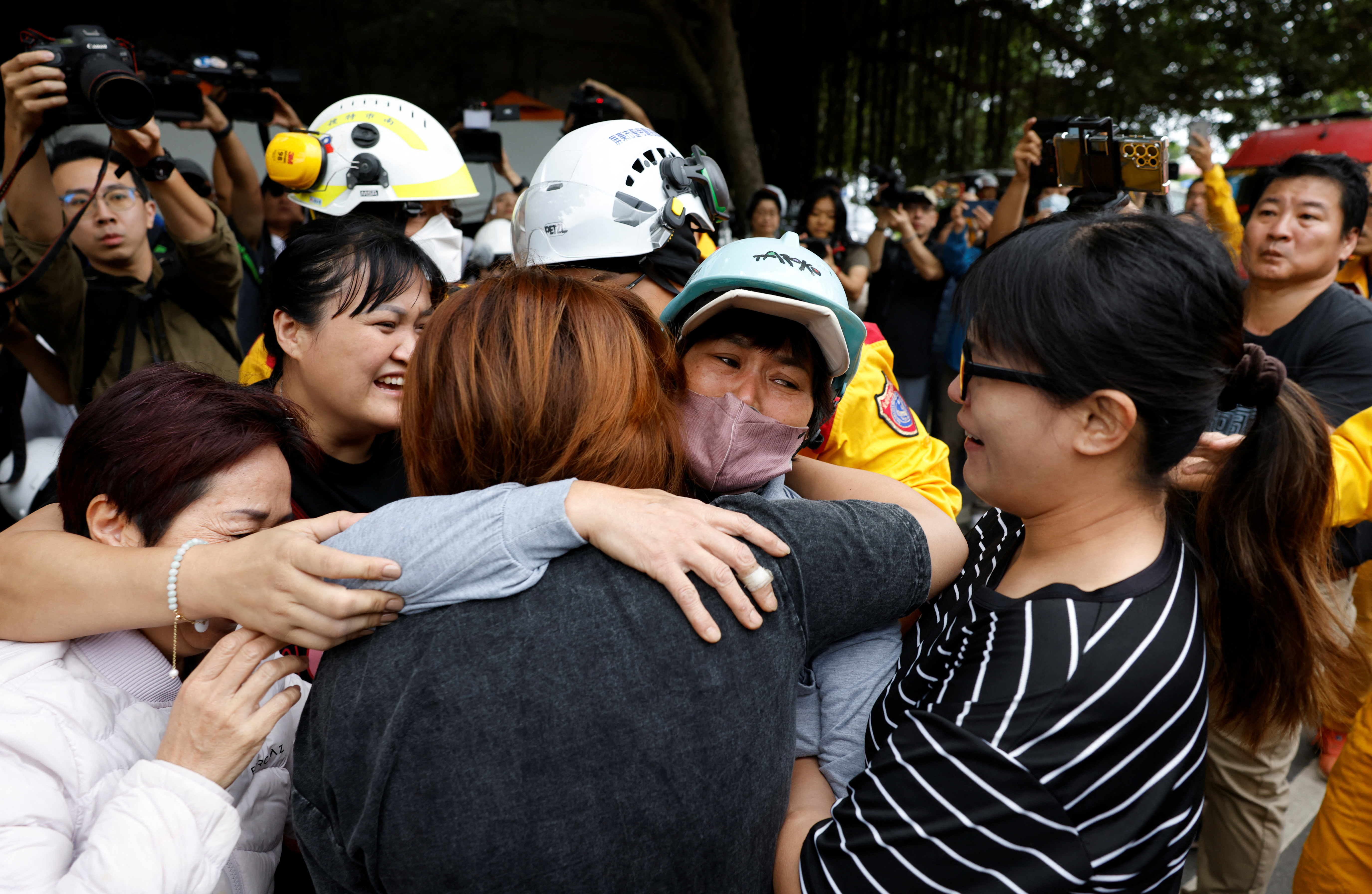 Family members hugging a woman rescued after the Taiwan earthquake