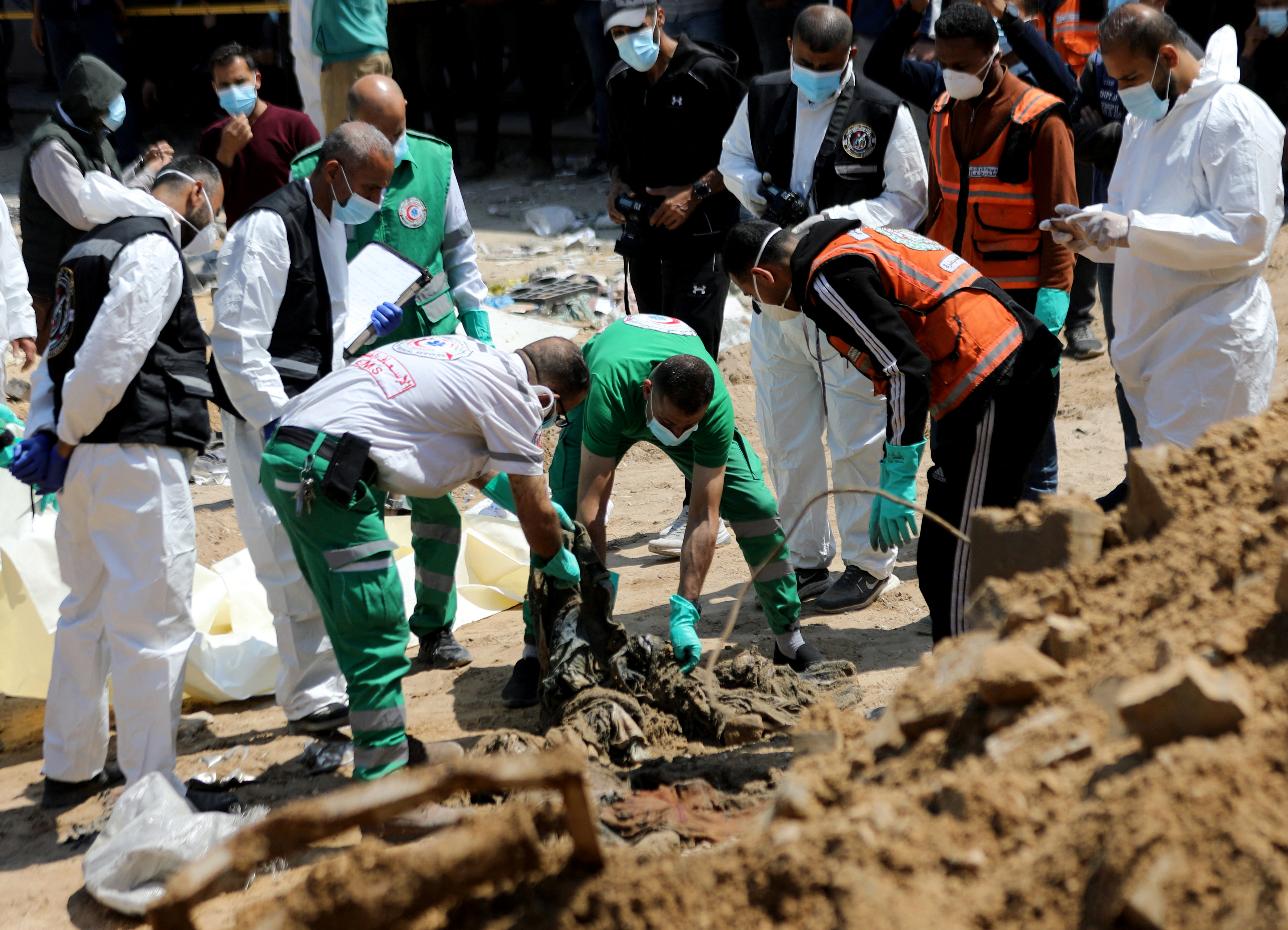 Rescuers and medics search for dead bodies inside the damaged Al Shifa Hospital after Israeli forces withdrew from the hospital and the area around it following a two-week operation