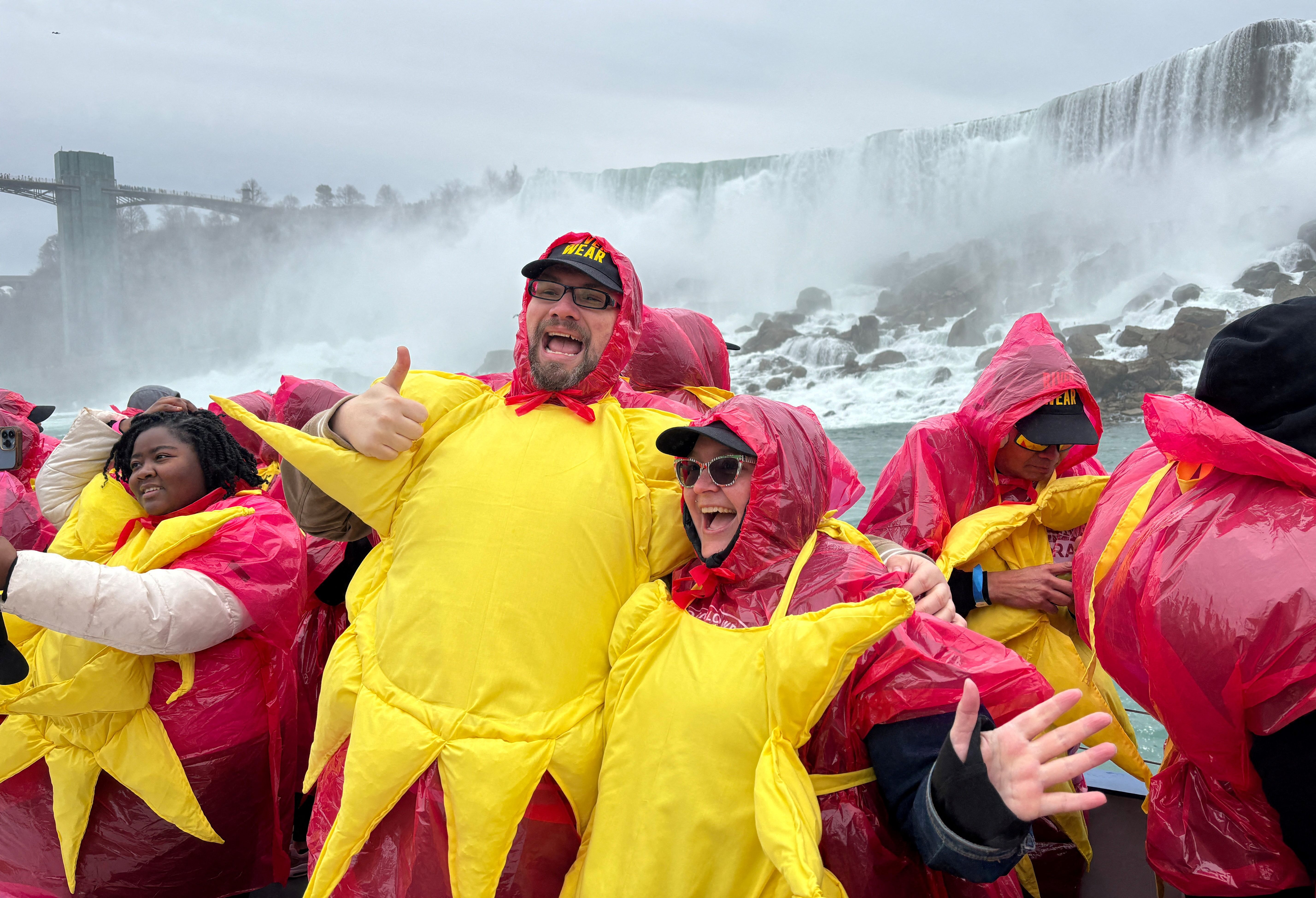 Some of the 309 people gathered to break the Guinness World Record for the largest group of people dressed as the sun pose on a sightseeing boat